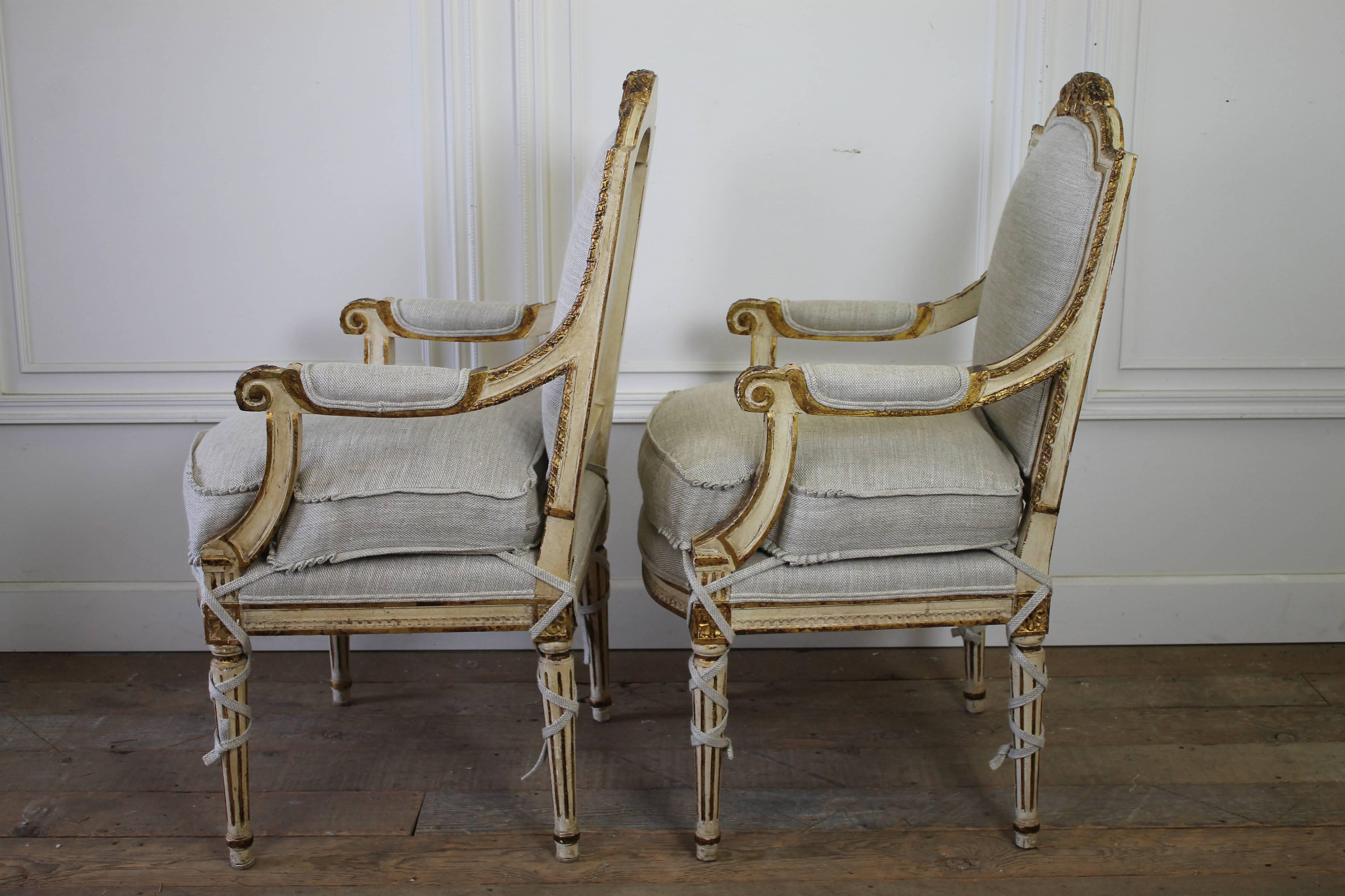 Pair of 20th Century Carved Painted and Gilt Upholstered Open Armchairs 1