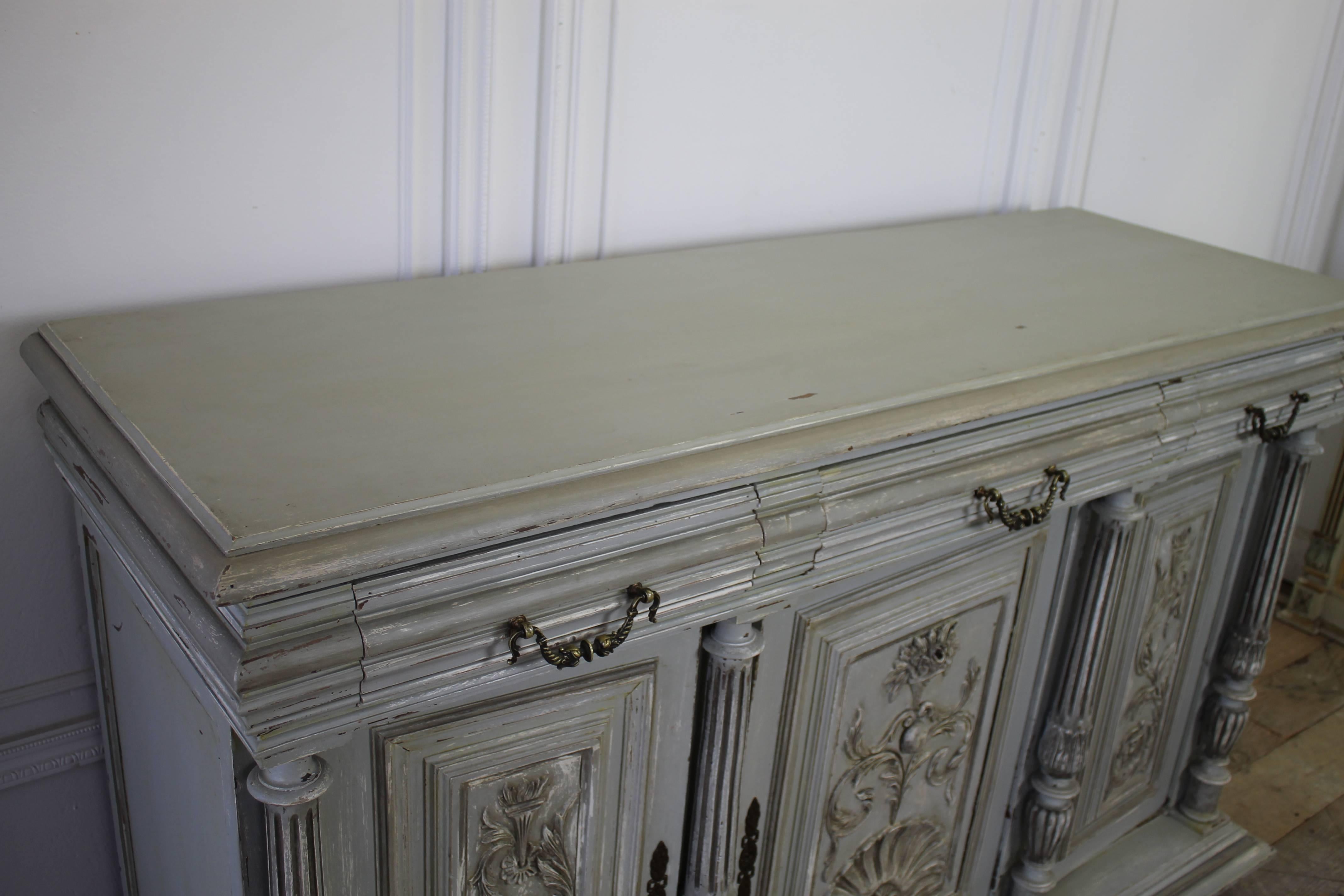 Early 20th century antique Italian painted oak server
Painted in a medium grey color with distressed style finish. Three drawers, and three doors open up to ample storage.
Drawers open and close nice, the bottom doors open and close with ease, the