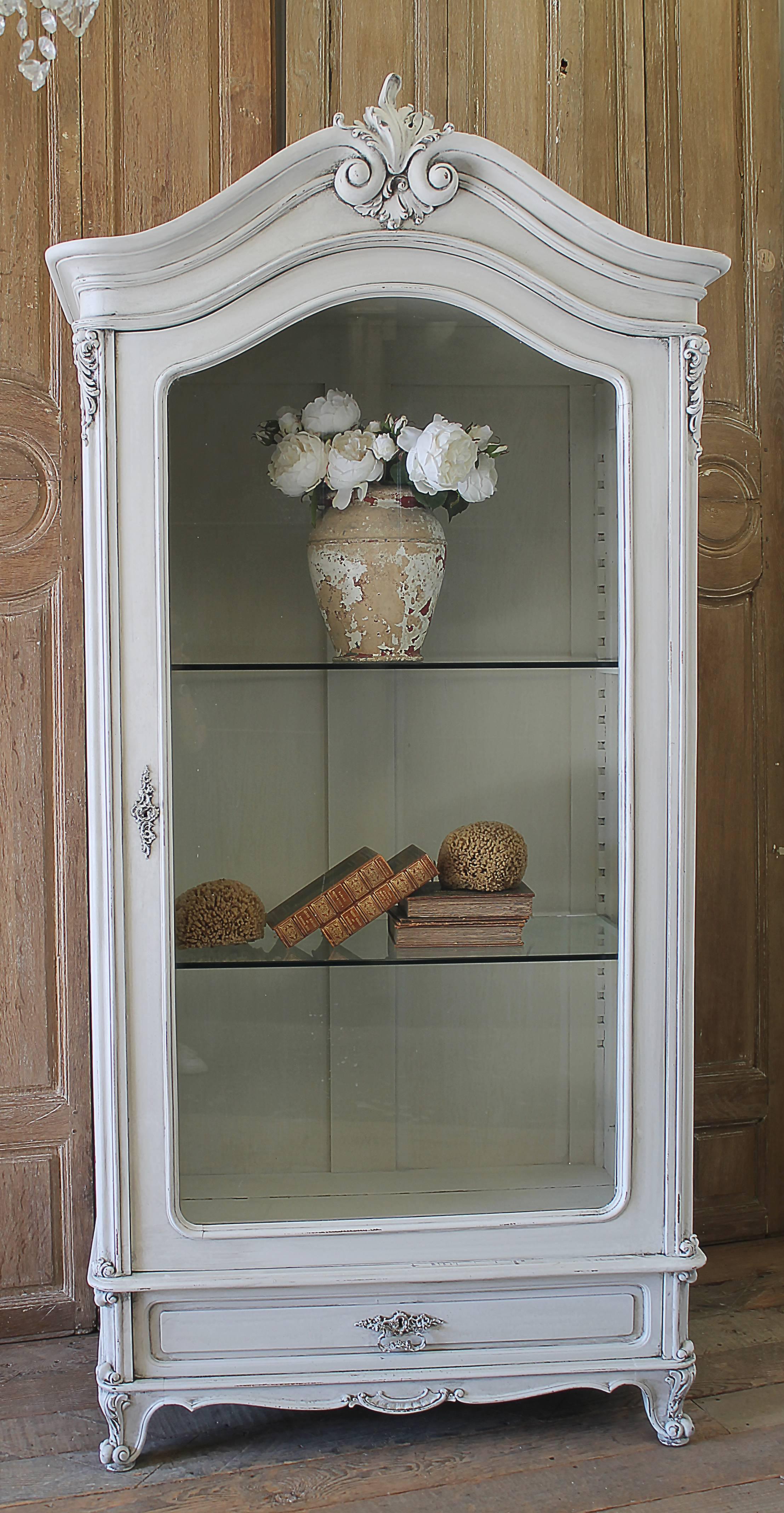 20th Century Petite French Display Armoire in the Louis XV style
We have painted this in a soft oyster white, with subtle areas of distress, and finished with an antique glaze. There are 2 adjustable glass shelves inside, and working drawer at the
