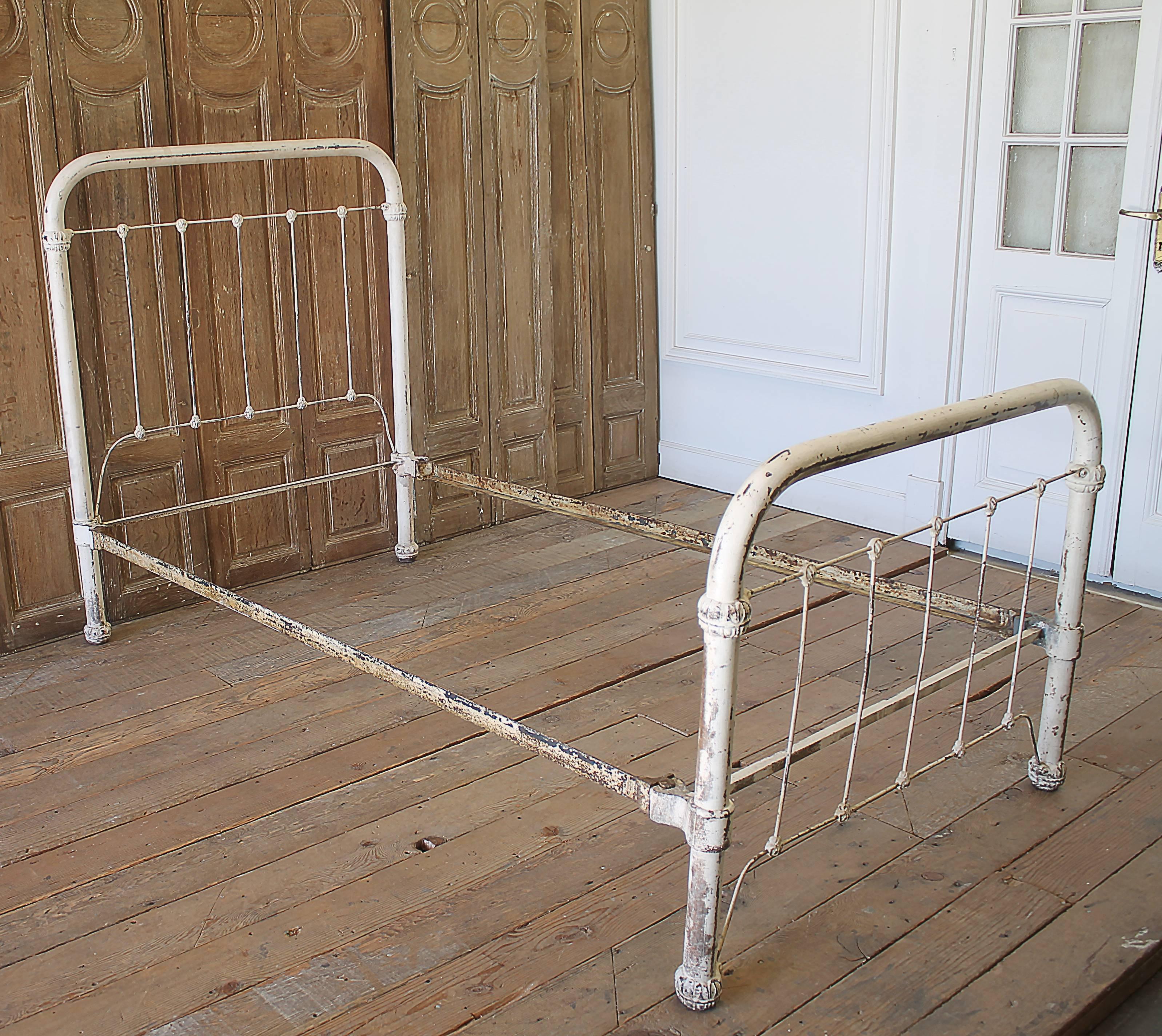 Antique wrought Iron bed in a twin size, with beautiful white paint perfect patina.  A pretty country farmhouse or shabby chic look.
Original rails, easy to assemble, very solid and sturdy. A heavy solid bed.
Twin iron bed measures: 43” w x 49.75”