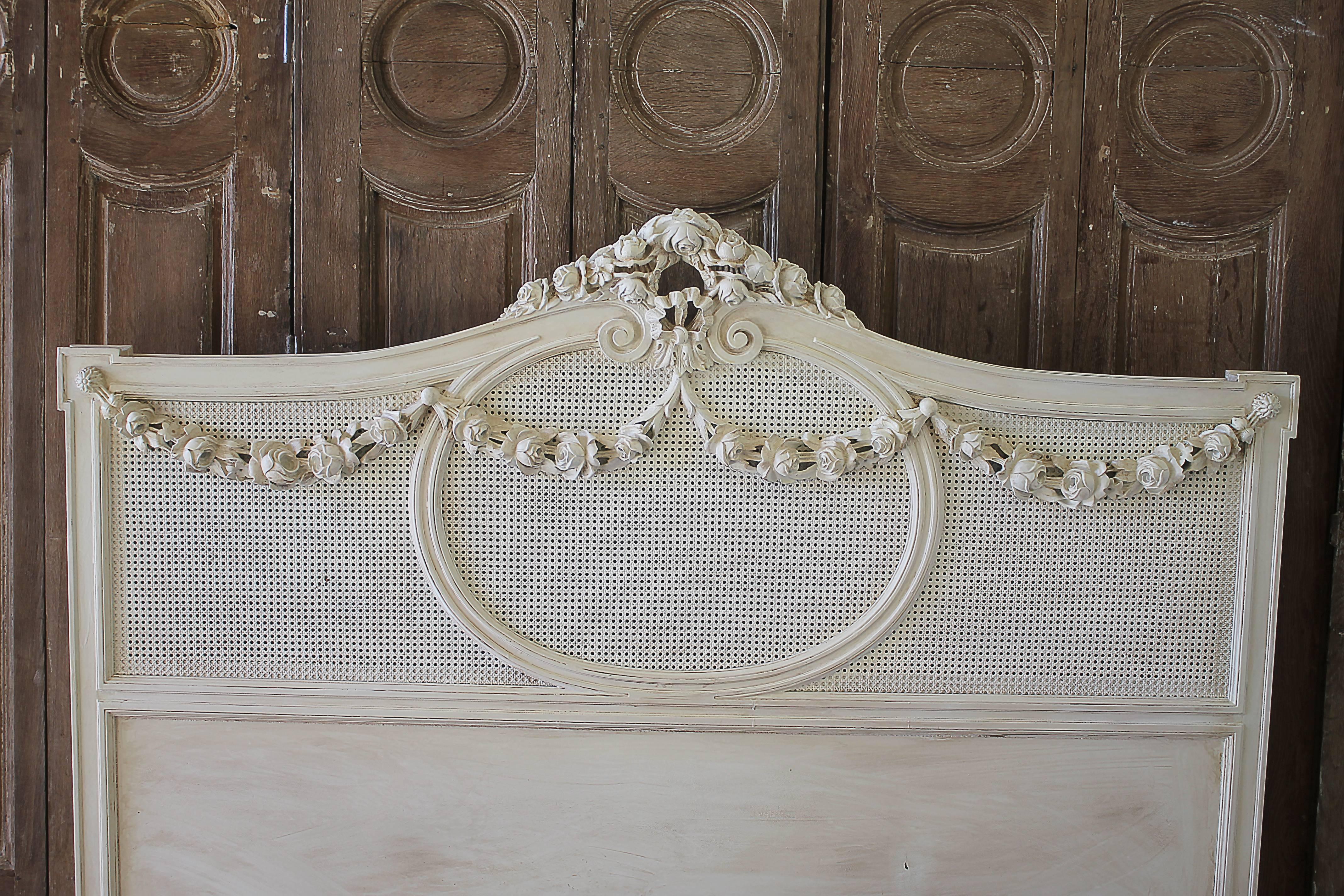 French Country Painted Cane and Roses Swag Bed Full or Queen
Beautiful bed painted in a creamy white color, with petite cane headboard and footboard, large garlands of roses swag down over the cane.  This bed has original rails to fit a standard