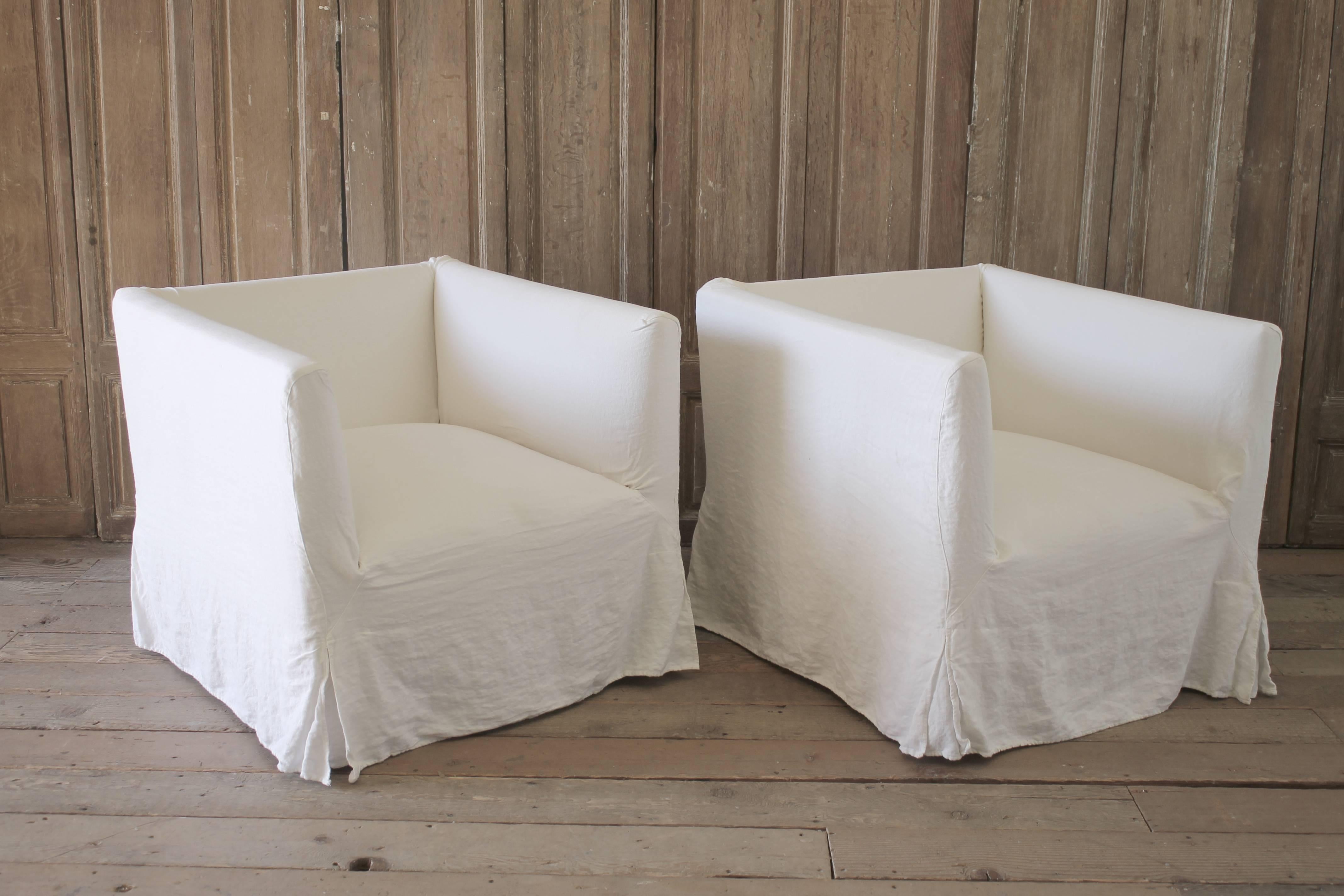 Pair of Linen Slip Covered Club Chairs with Wood Base
These have a newly reupholstered canvas upholstery with distressed wood carved base.  The linen slip covers are fairly newer, look clean, ready to use.
Tight seat, tight back, comfortable