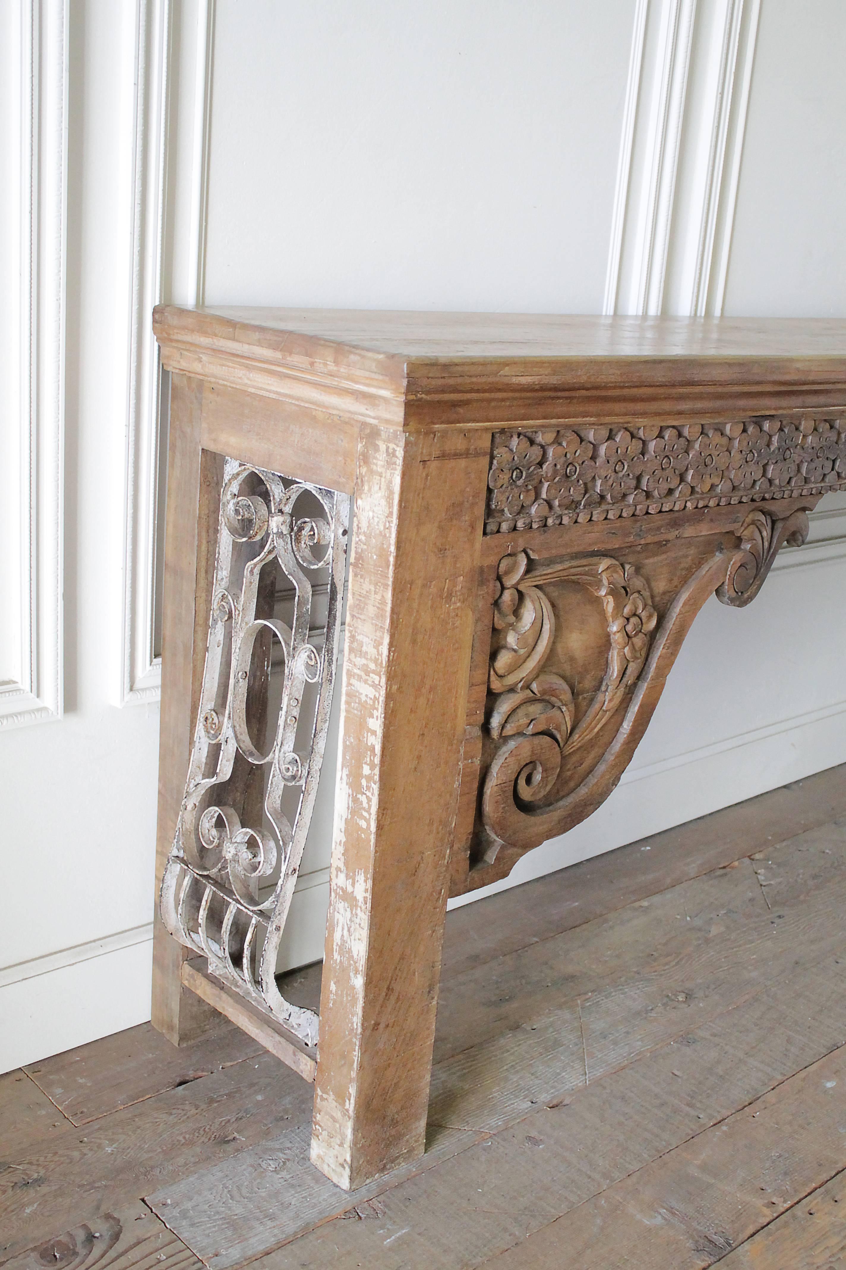 Decorative wood and iron Moroccan style console sofa table 
Finish is distressed, looks like this wood could be oak, with painted scrapped finish. The sides have a decorative iron inset that also has a distressed painted finish.
Measures: 95
