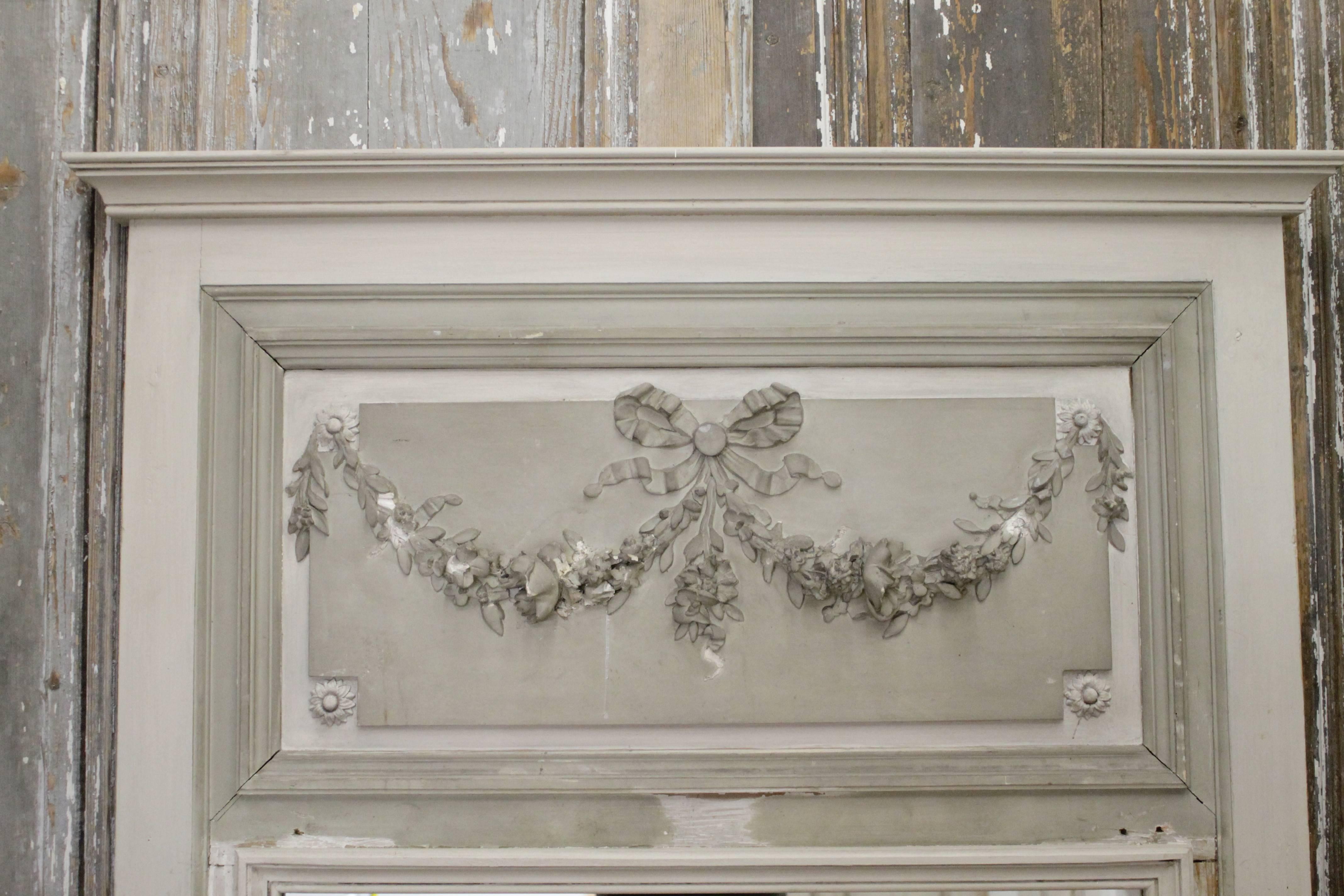 Intricate roses carvings and original French grey green paint. We added a mirror and crown molding to this frame wall panel,
circa 1920.
