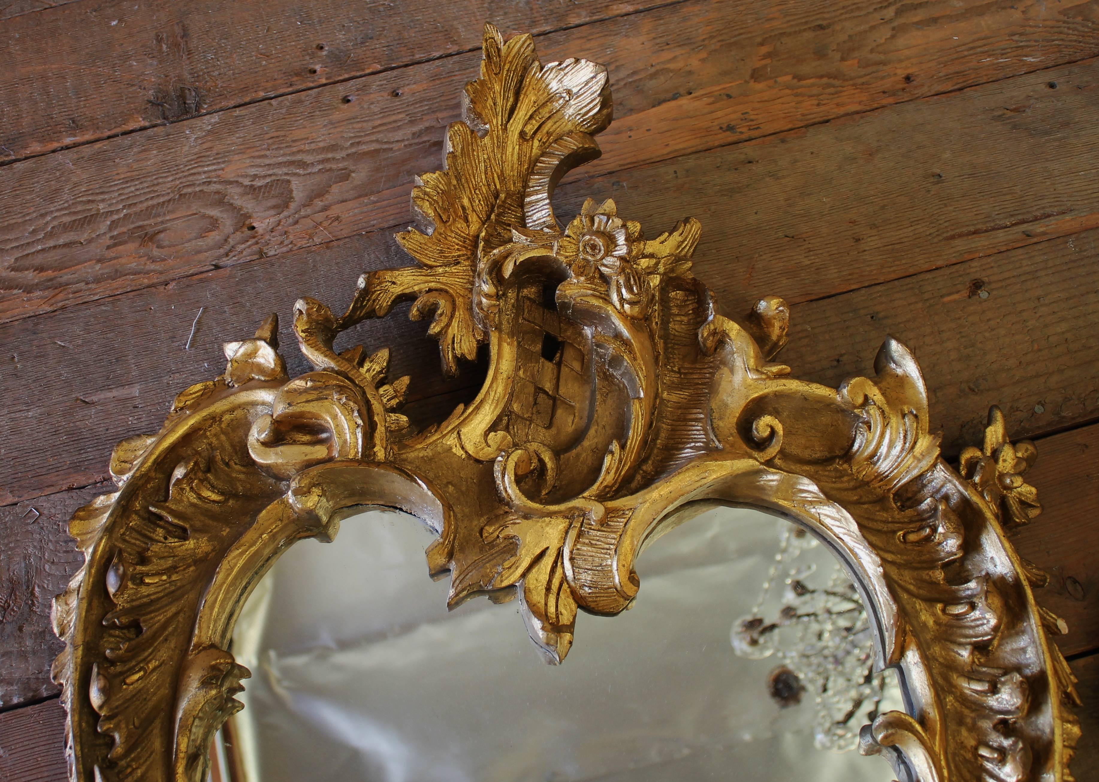 Late 19th century wood carved Rococo style mirrors. Mirrors are fully reflective. Ready to hang.