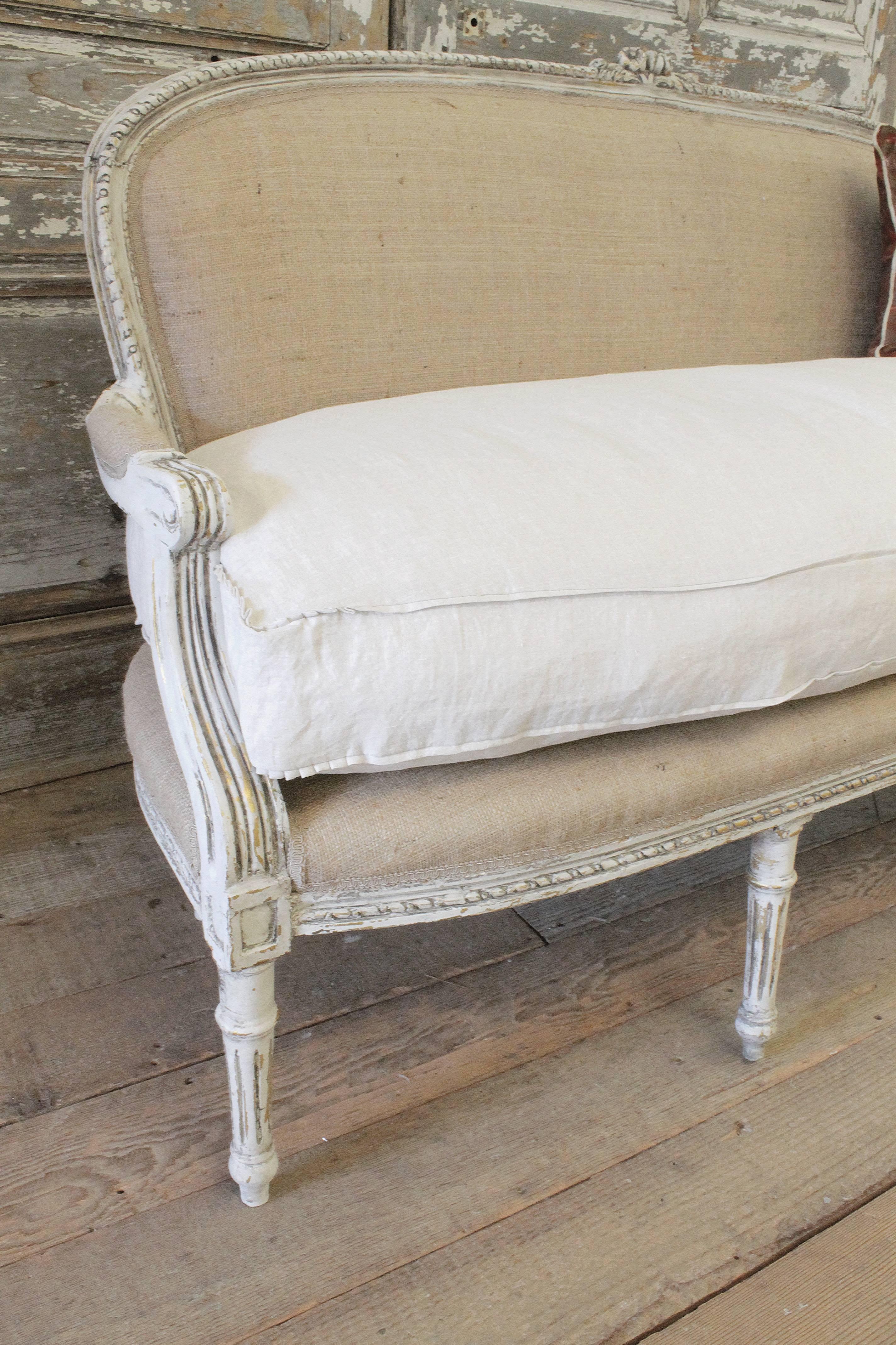 This vintage settee is painted in our oyster finish and upholstered in burlap and our natural linen. A brand new down wrapped cushion has been slip covered in our 100% Irish linen, can be removed if needed. 
Good condition, sturdy ready for