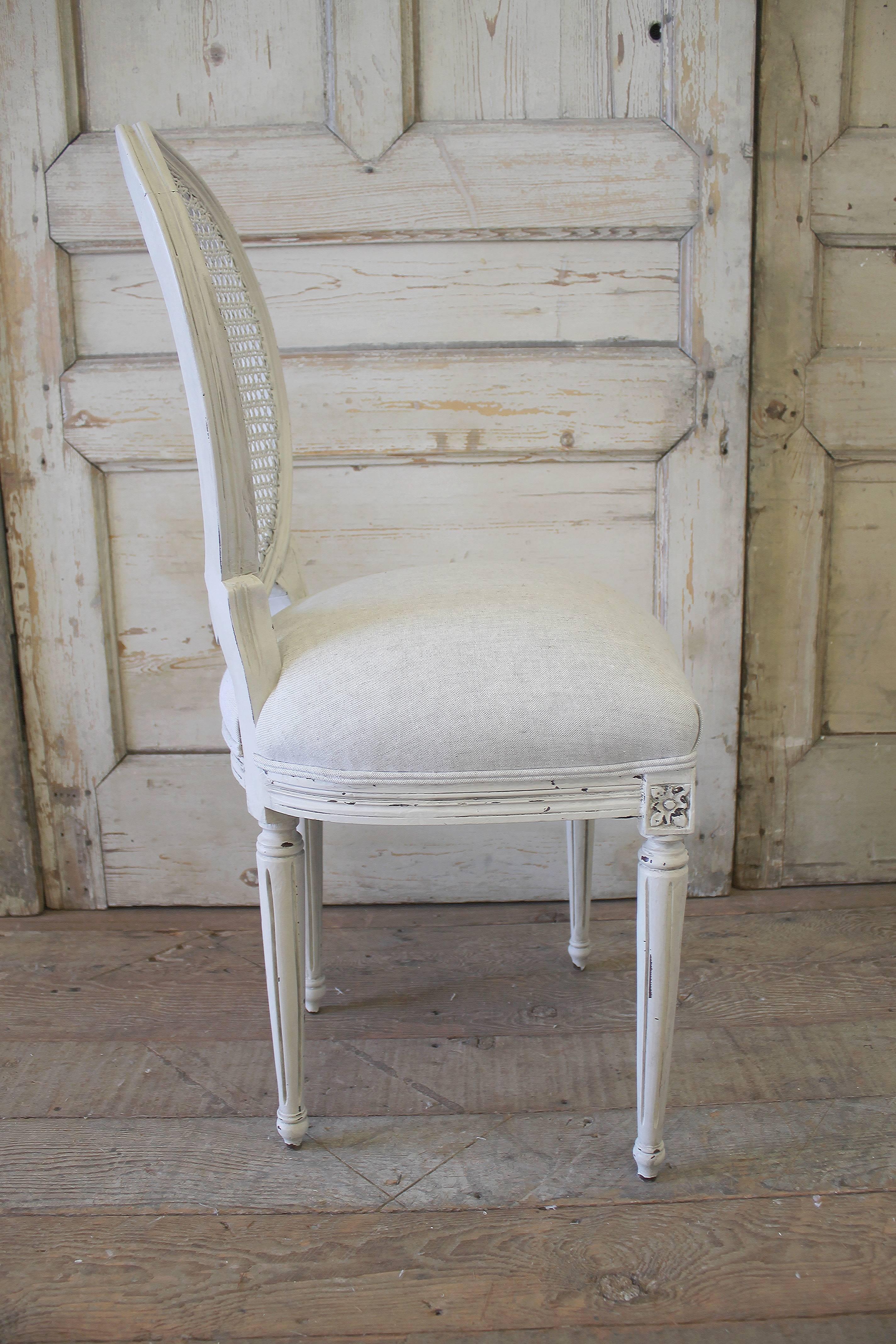 Painted in a soft white with antique finish. We upholstered the seats in 100% pure Belgian linen. All the seats springs were retied and all legs are strong and sturdy ready for everyday use. Cane is in great condition on all chairs.
Set of six side