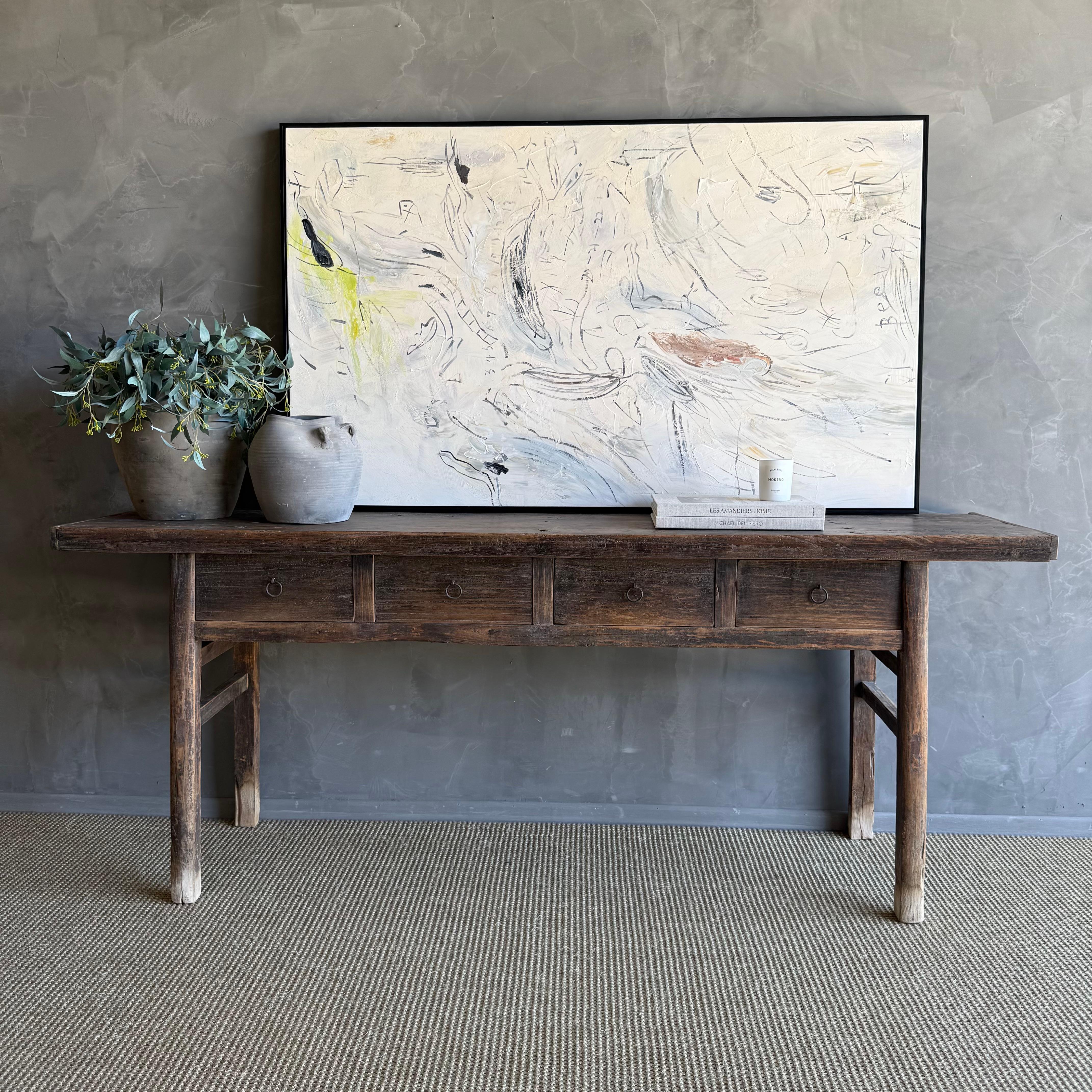 This charming vintage elm wood console is a one-of-a-kind piece with beautiful age and patina that adds character to any space. Its patina painted elm wood finish showcases the natural beauty of the wood, while the solid elm wood original hardware