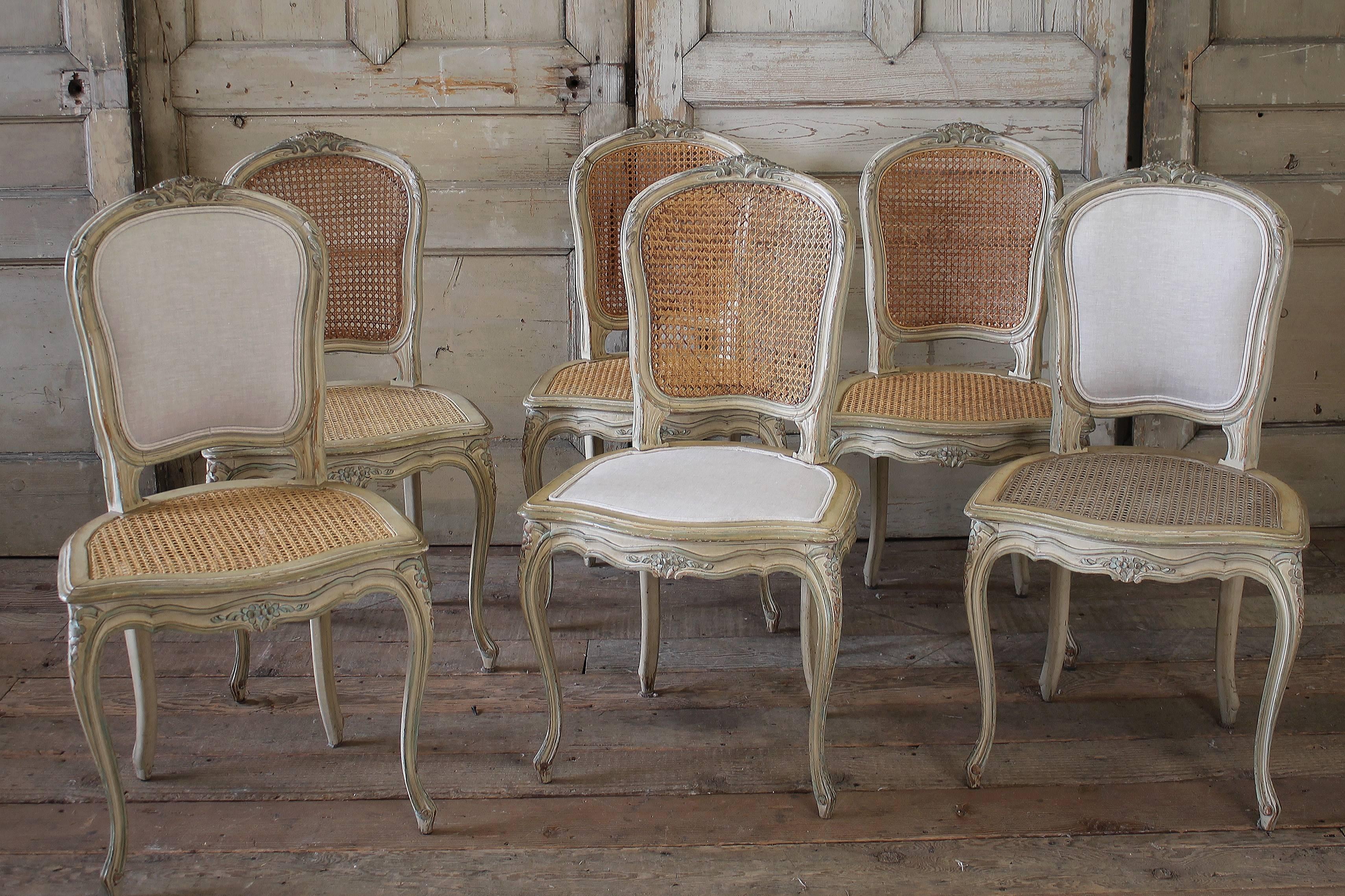 Beautiful set of six side dining chairs. There are two upholstered back end chairs and four Frenc cane side chairs. All of the chairs have new slip covers with a ruffle and ballet tie leg. The upholstery and slip covers have been done in a soft