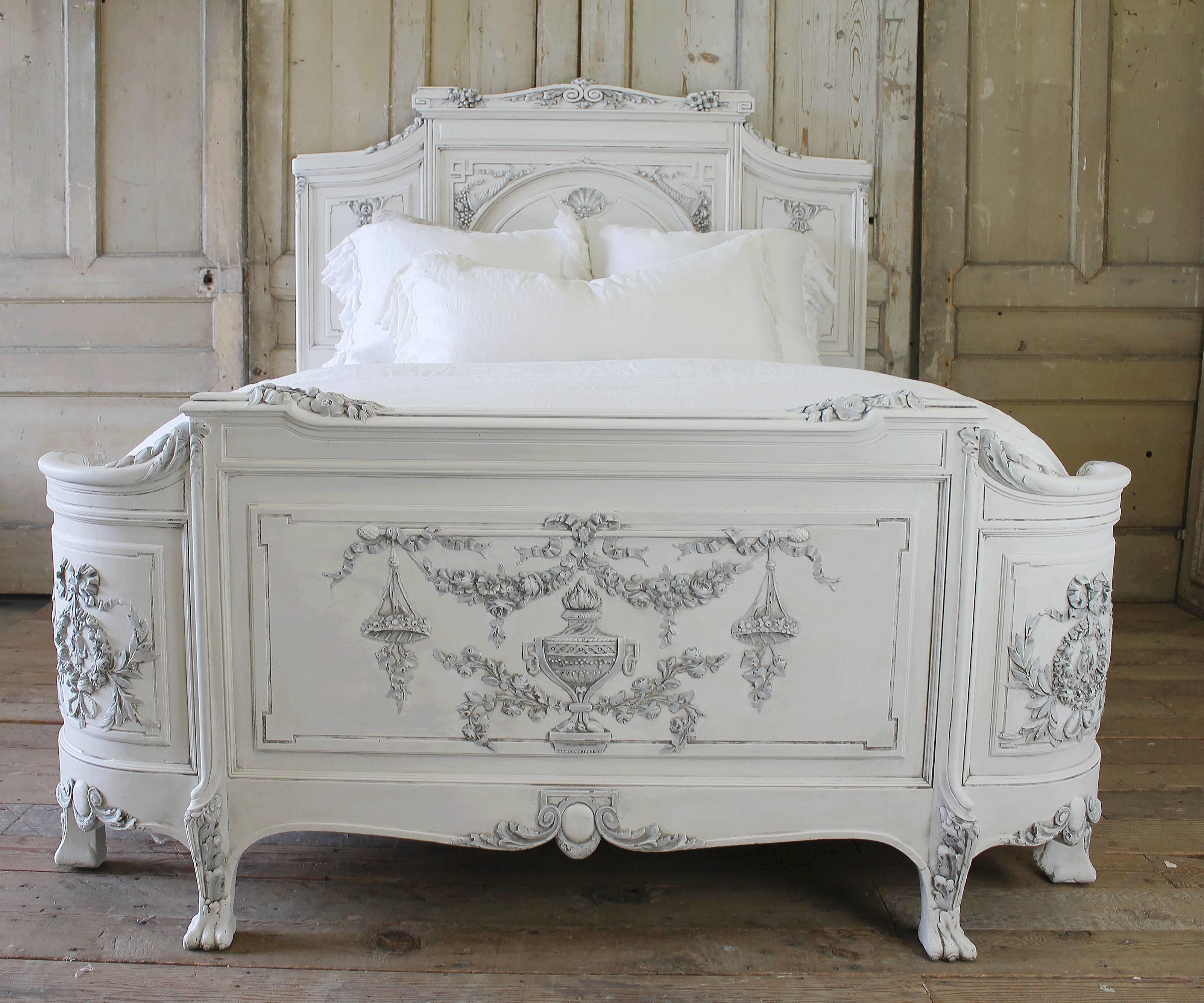 Gorgeous antique French Country style bed painted in a soft white, with grey antique accents. The finish is a two-tone with a hand rubbed finish to give the look of a time worn patina. The carvings are so extraordinary, headboard has a clam shell