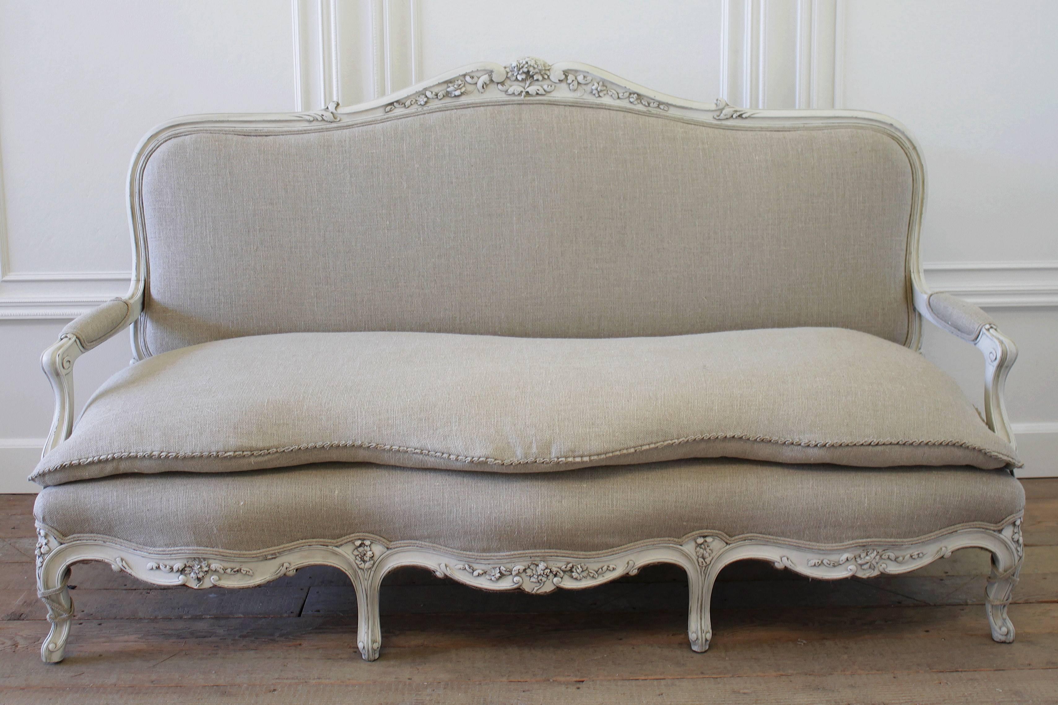 This gorgeous sofa is one of our favorites! The frame is a solid hand-carved mahogany frame that has been painted in our oyster white, with an antique glazed finish. Perfect french country charm! The upholstery was done in a Burlap style 14 oz.