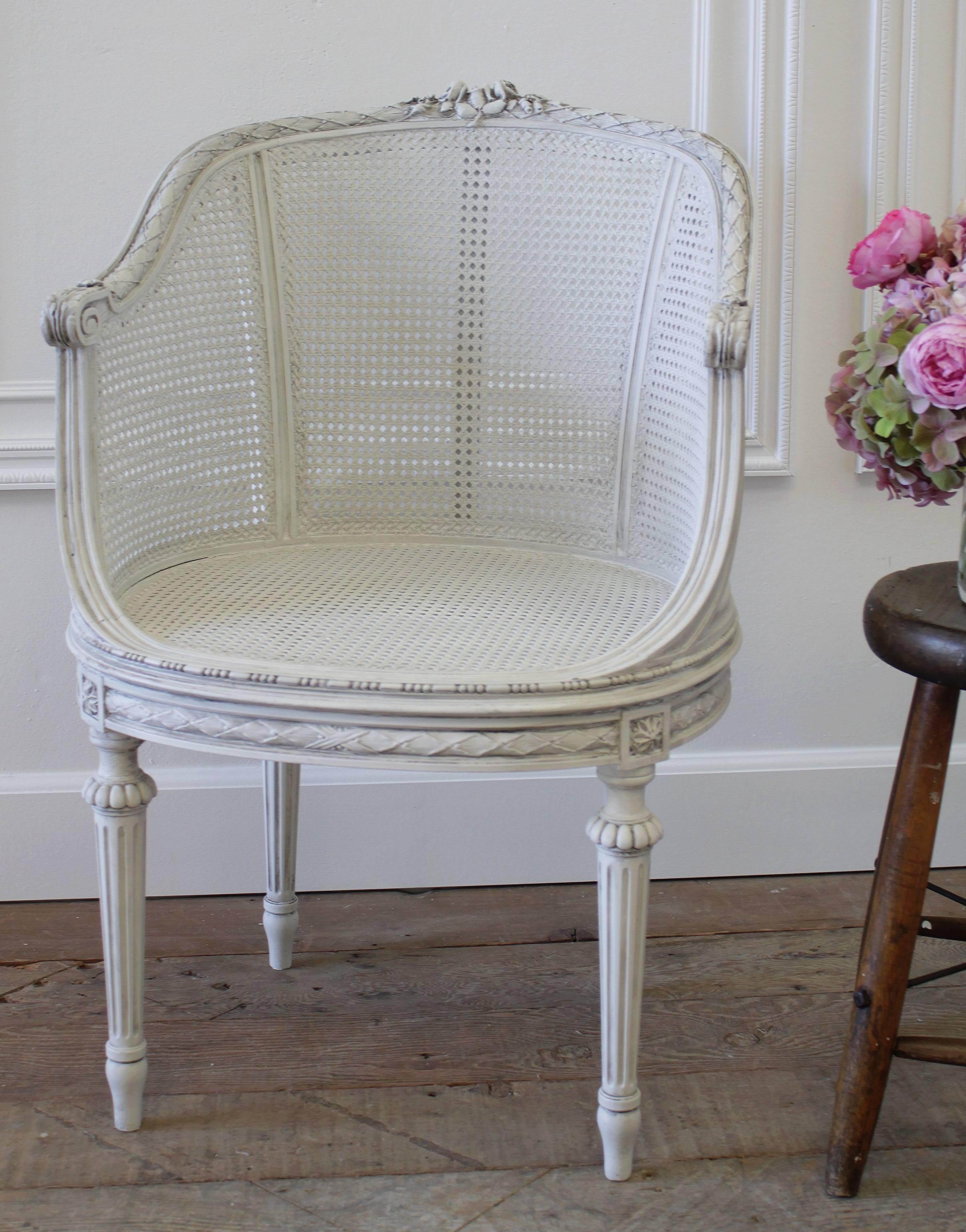 Gorgeous little accent chair has been finished in our signature oyster white paint finish, with a hand rubbed antique glaze. The cane is absolutely perfect, strong, and ready for everyday use.
The carvings at top are of roses, leaves and laurel