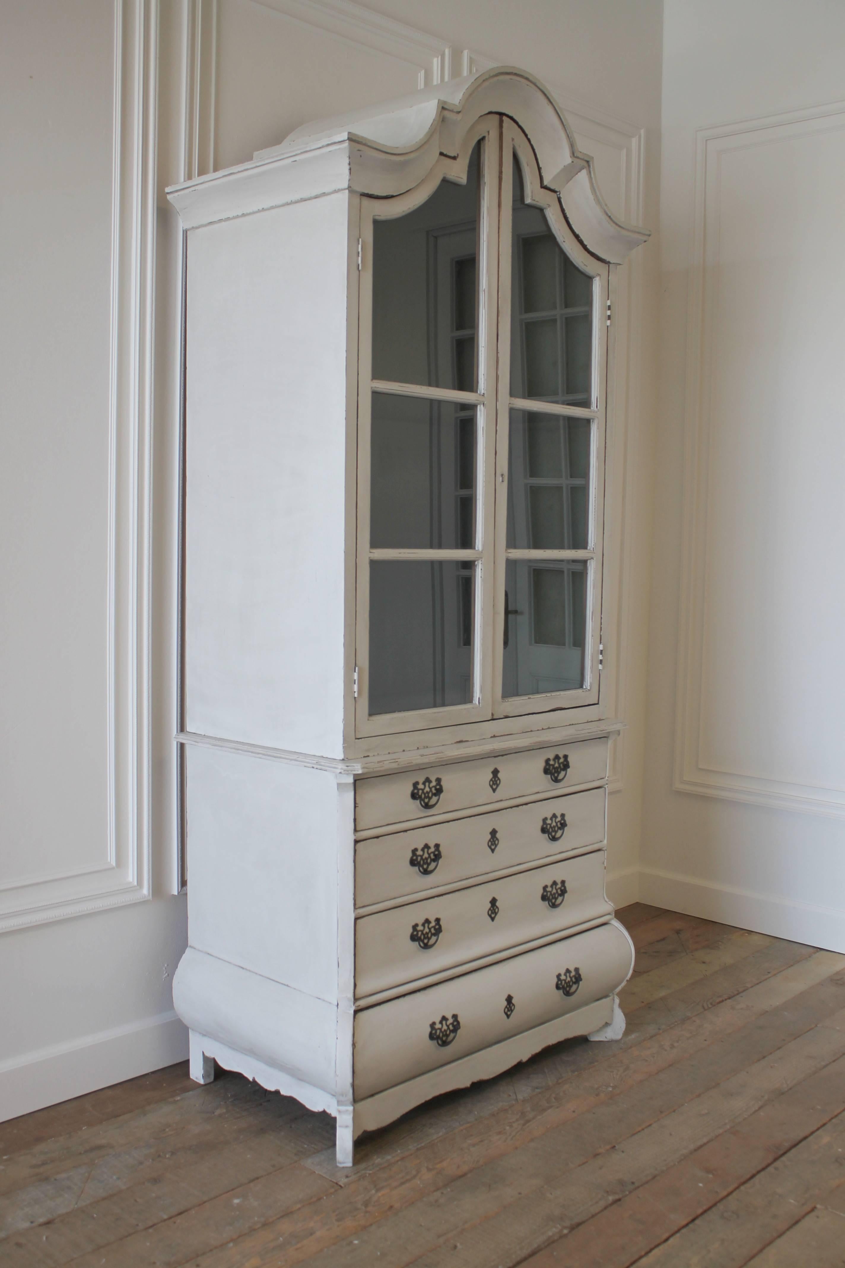 Beautiful designer display in the Italian style. Solid pine, painted in a soft oyster finish, with faux glaze. The finish has the appearance of a time worn patina. The commode bottom has solid pine drawers with a dovetail finish. The drawers all
