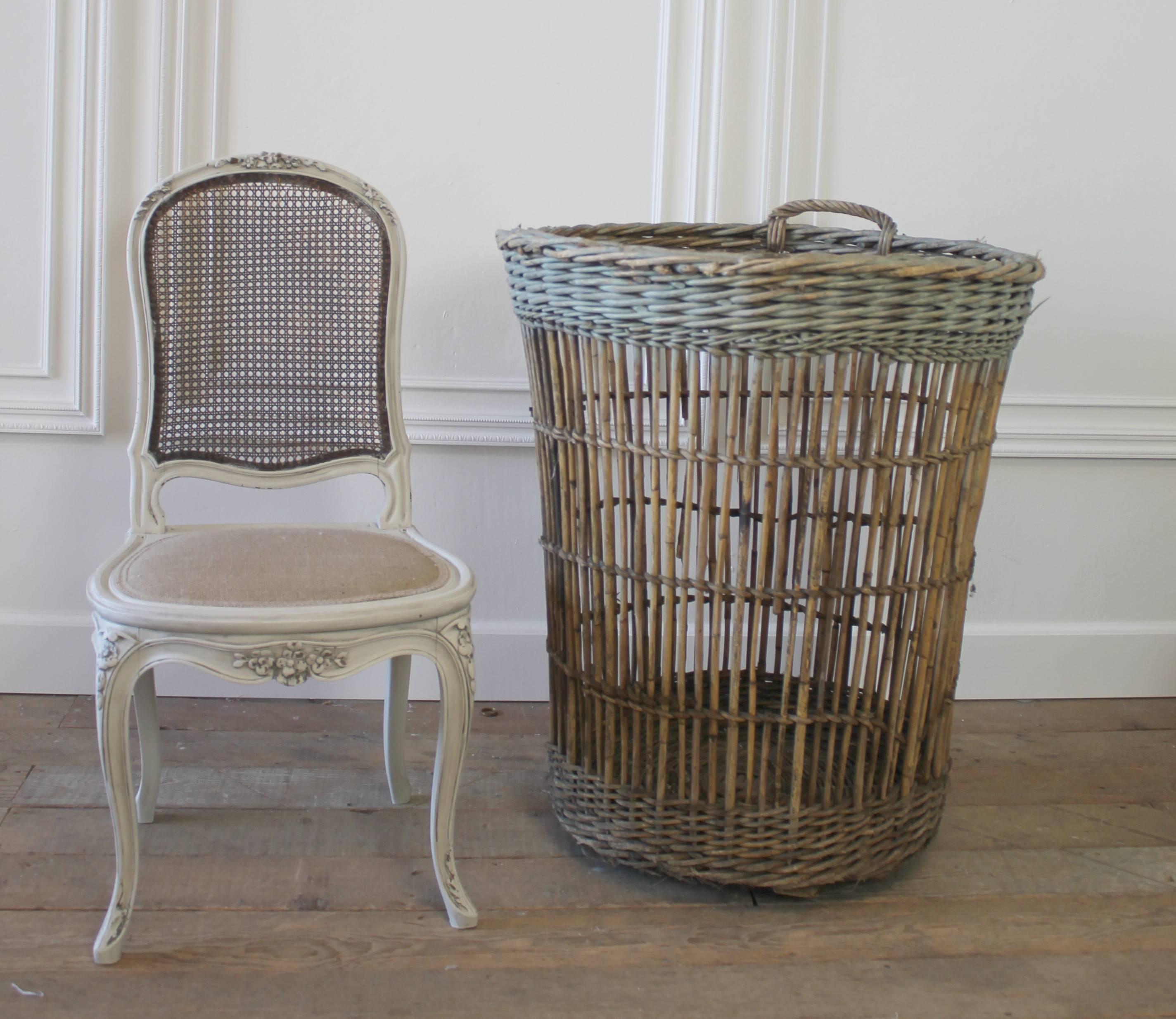 Large French harvest baskets made of woven willow and wood from the Champagne region of Burgundy, France. Beautifully woven with a painted rim, in a faded soft aqua color. The finish is warm and rich. One sits on a wooden base, with double handles.