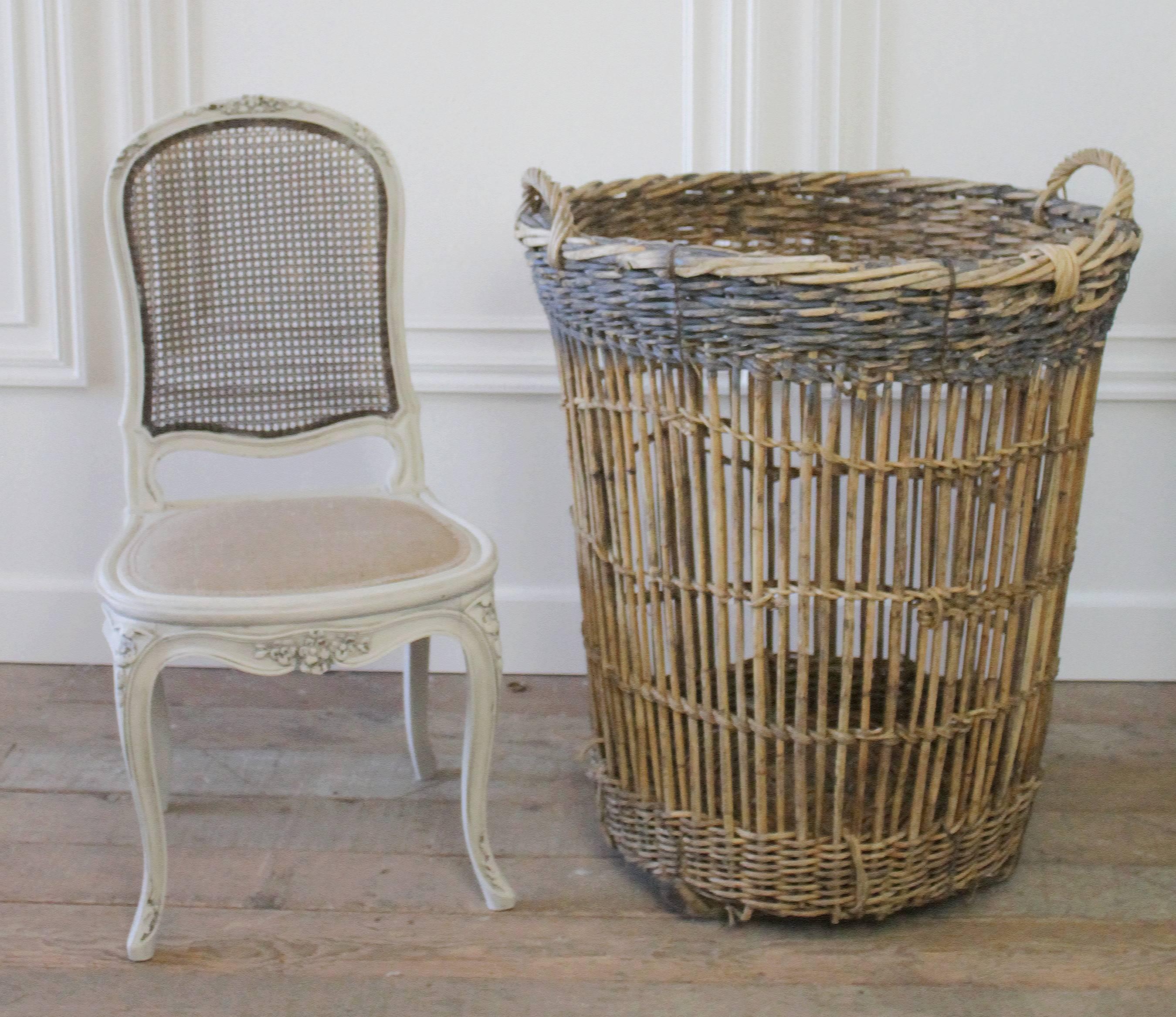 We have just 1 left. Large French harvest baskets made of woven willow and wood from the Champagne region of Burgundy, France. Beautifully woven with a painted rim, in a faded soft French cornflower blue color. The finish is warm and rich. One sits