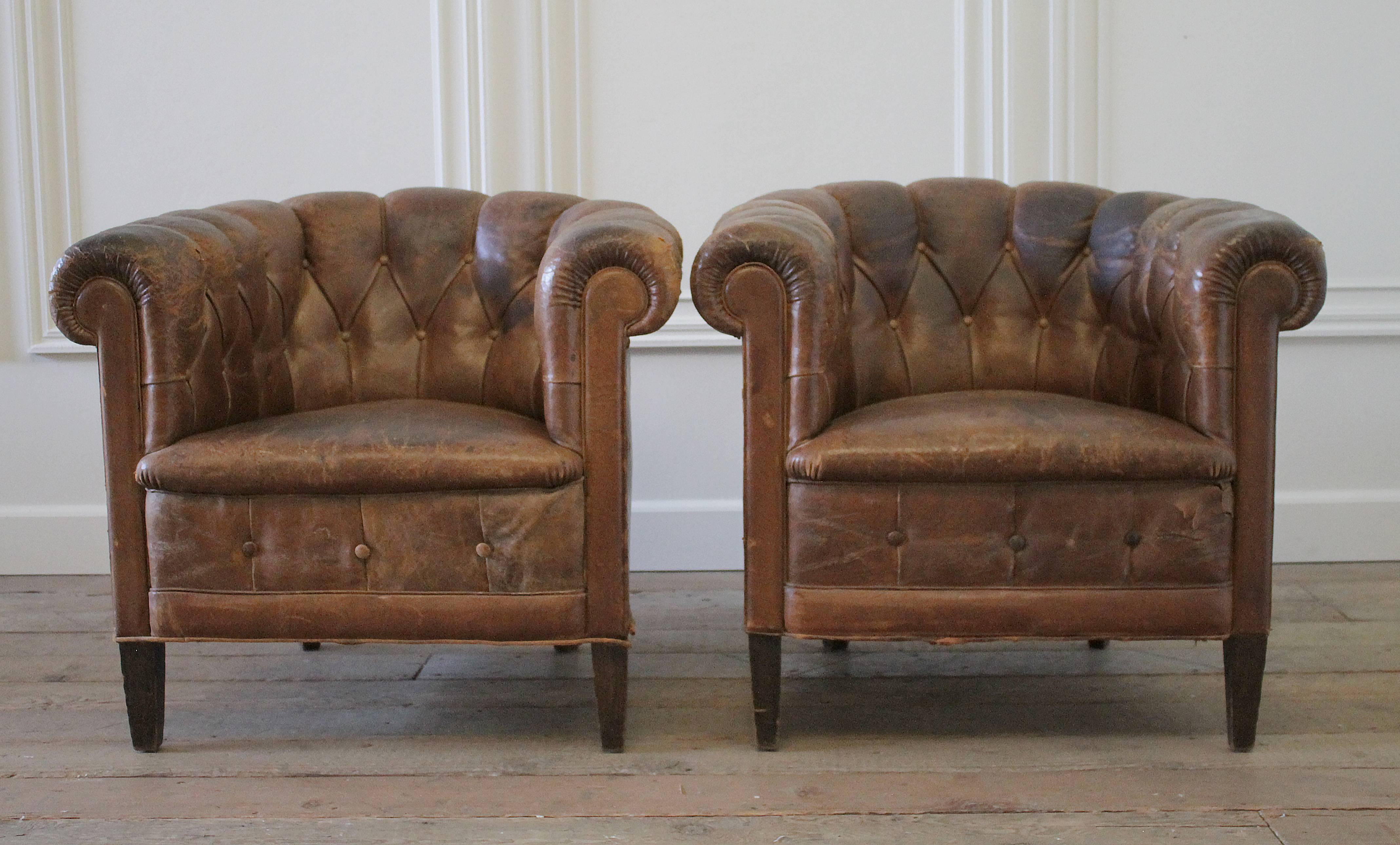 These French leather tub chairs have the original lambskin leather, that is very distressed and aged, circa 1930. The frames are in good condition, and are sturdy, the seats sit nicely, just some of the leather around the outside arms and back have