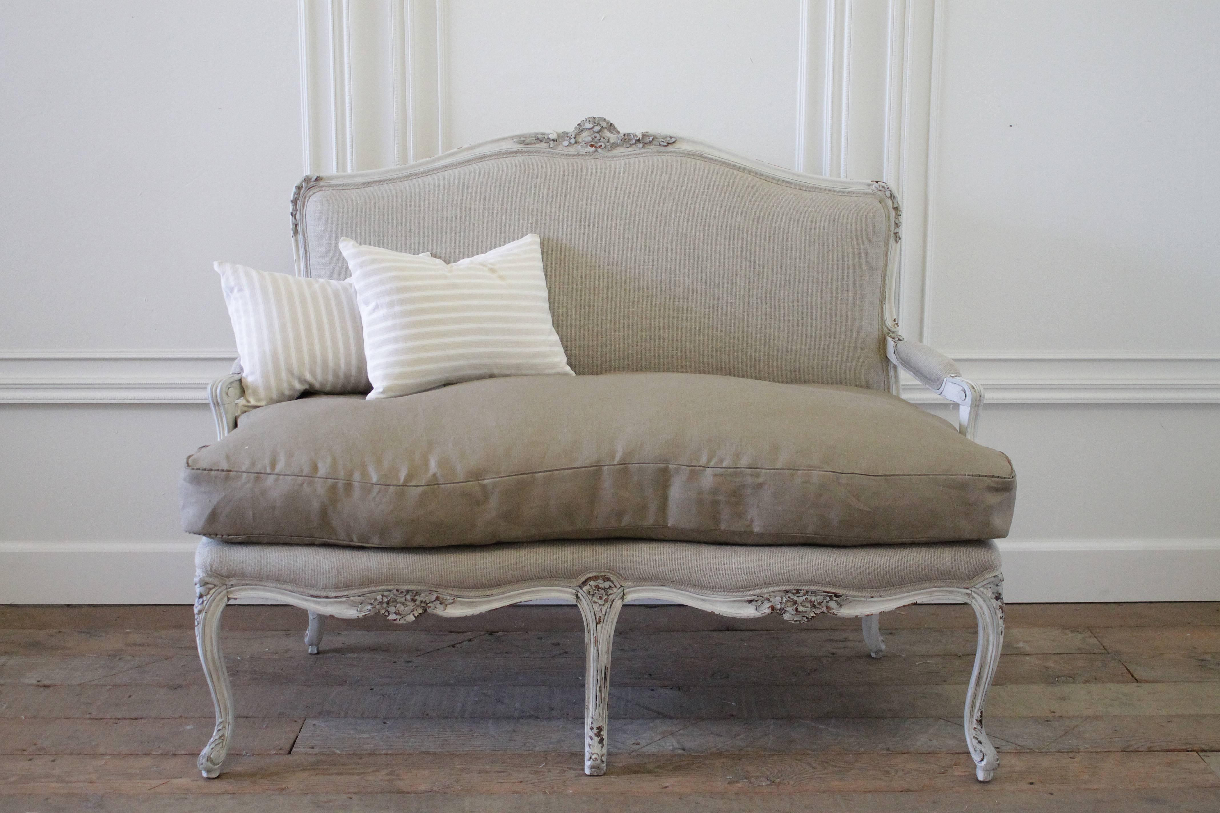 Fabulous Louis XV style carved country French settee in our soft Irish nubby linen. We painted this walnut frame in a tone on tone French grey with darker accented carvings. The settee has a subtle distressed finish, with an antique glaze to give a