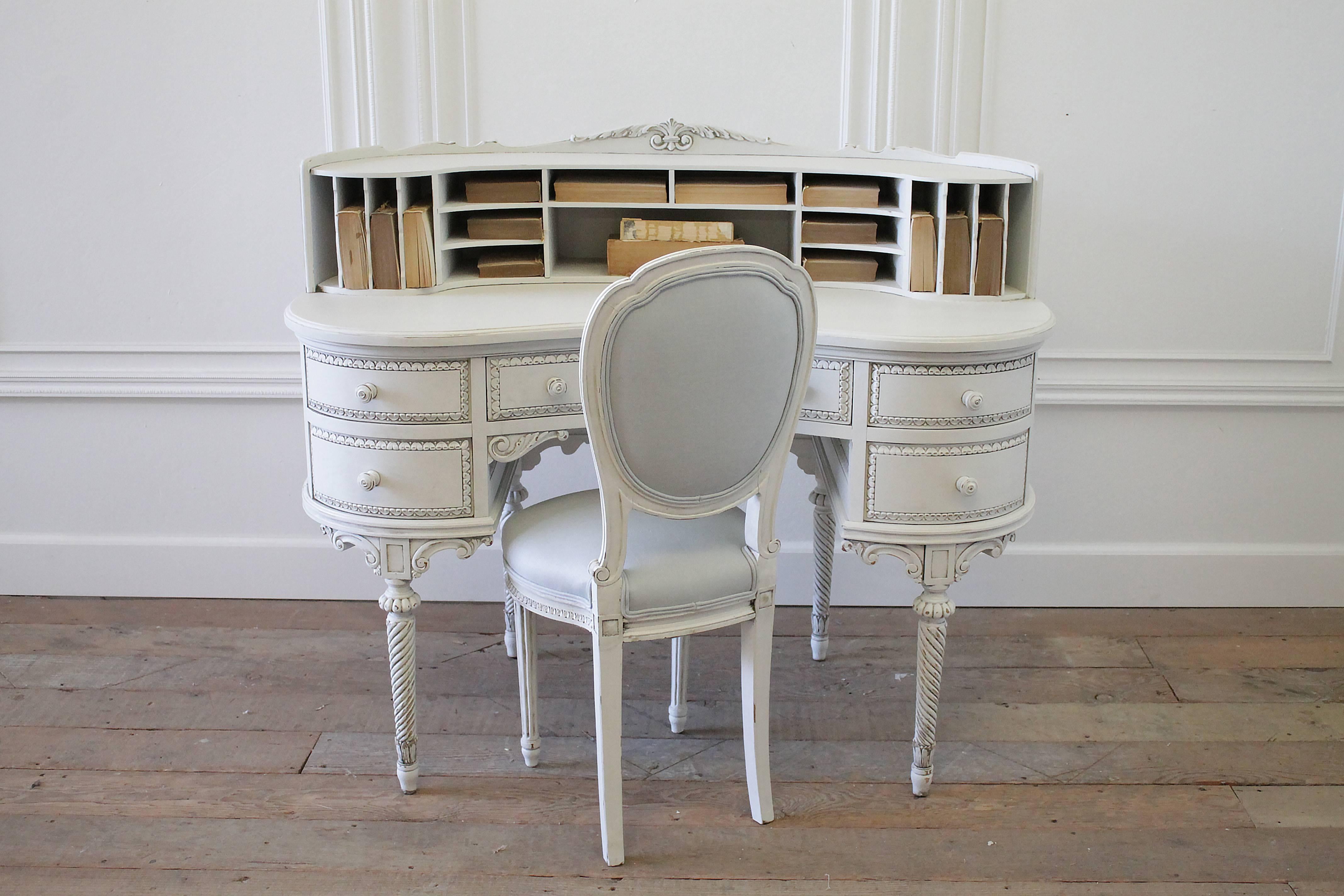 Beautiful kidney bean shaped desk has been painted in our oyster white, with subtle distressing and finished with an antique glaze. The desk has plenty of storage, with five working drawers, 17 open mail slots above. Beautifully carved with twisted
