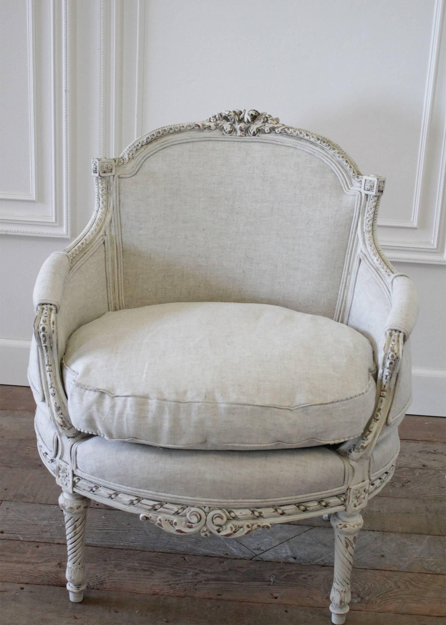 Beautiful antique chair circa 1920 with our oyster white paint finish, has been reupholstered in a heavy Belgian linen. The chair has a subtle distressed finish, with glaze to give the look of a time worn patina. The color has tones of creamy white,