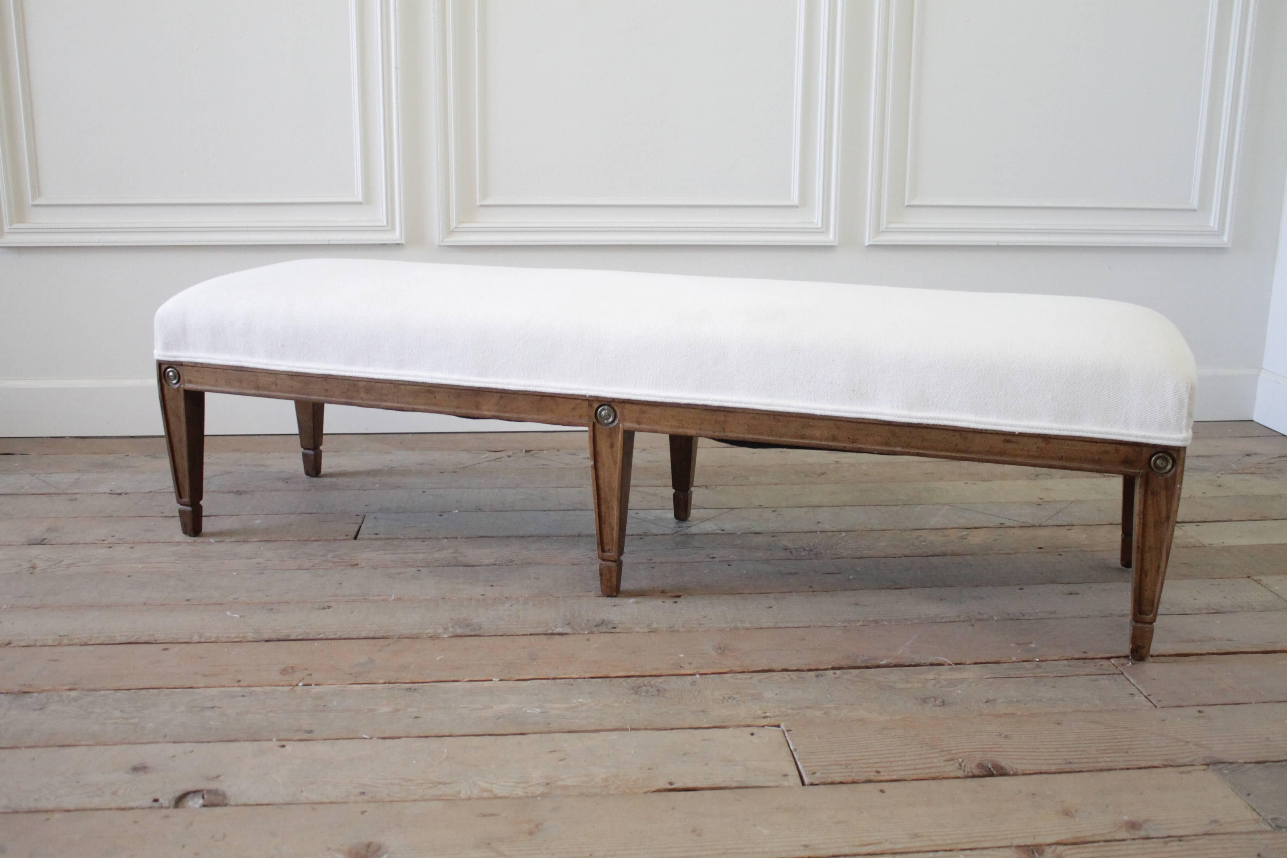 Beautiful vintage bench, in a medium wood tone finish, slip covered in soft light natural linen, with double ruffle and mini ruffle flange. 100% machine washable, this bench is original medium wood tone and off-white chenille style material. We can