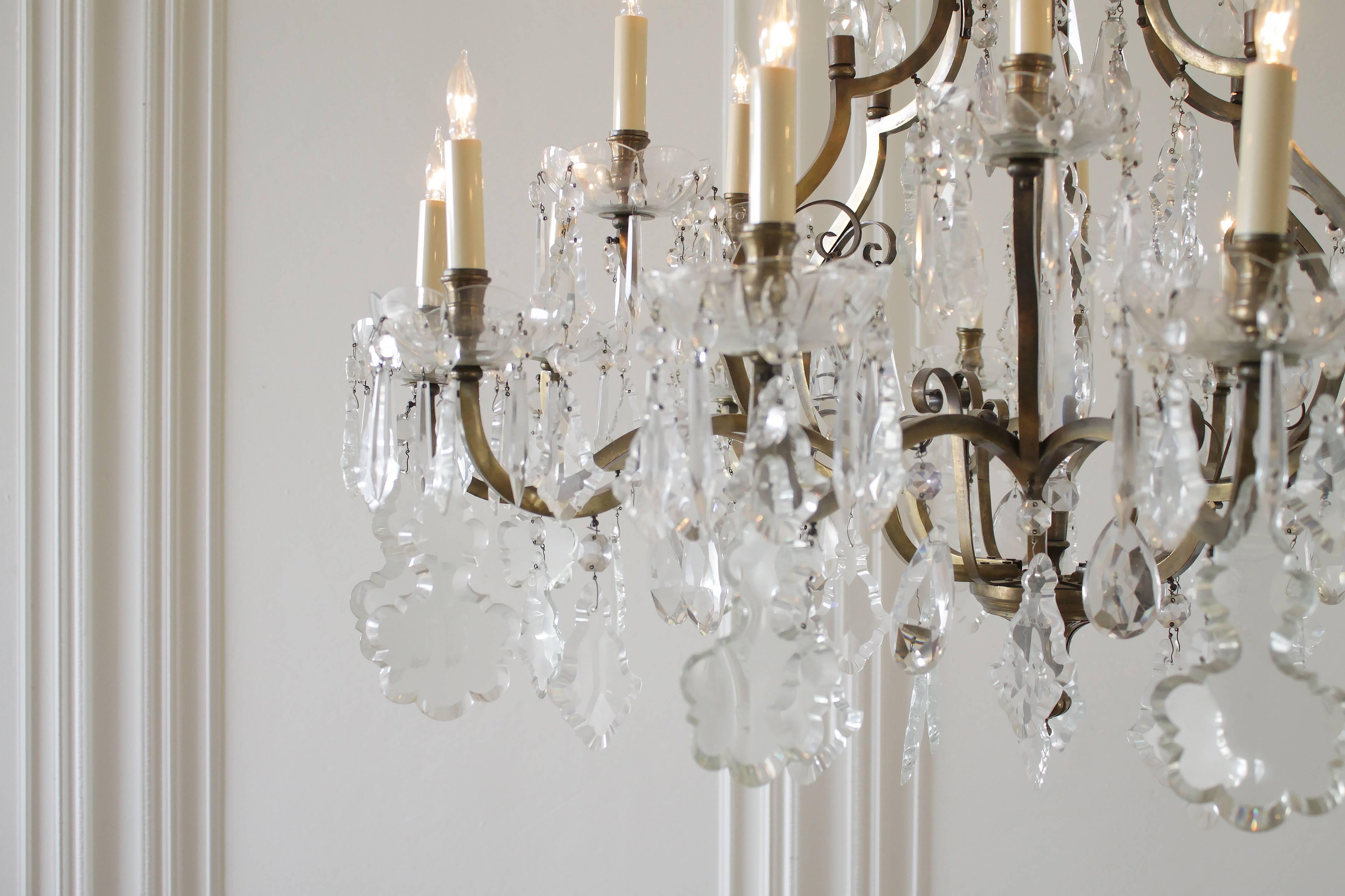 Impressive large eighteen-light chandelier dripping with large French crystal pendants, and unusual crystal shapes. A large crystal sphere center, with dangling tear drops and diamond shapes along the inner portion of the chandelier. Make a