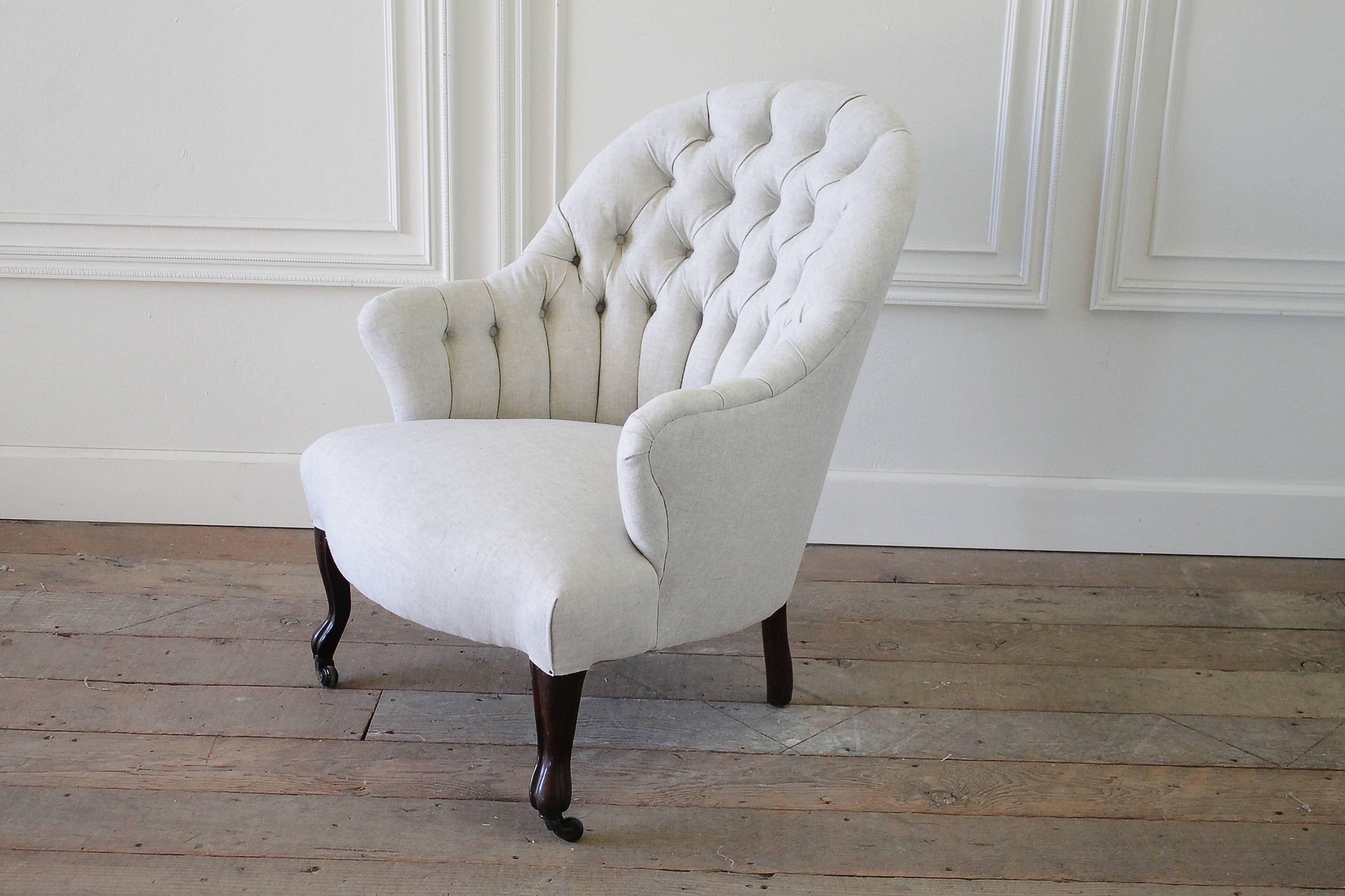 Beautiful and comfortable, this Napoleon chair has been reupholstered in one of our soft natural Belgian linens. A dark espresso colored legs, with caster wheels on the two front. Legs are very solid and sturdy, can be used for everyday