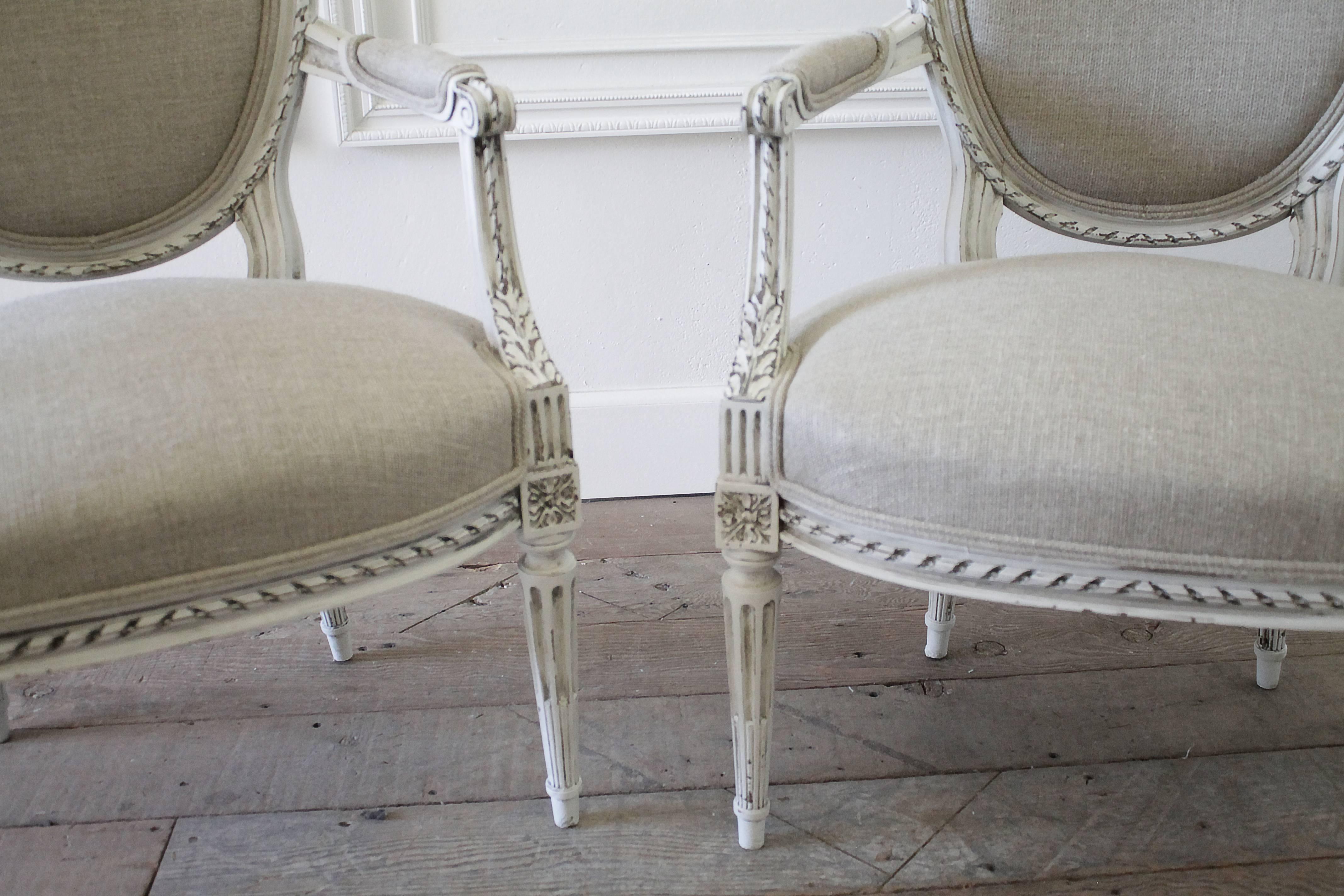 Fabulous pair of Louis XVI armchairs have our oyster white painted finish, hand distressed with antique glazed finish to give the look of a time worn patina. These lovely set of armchairs match a settee and pair of side chairs (listed