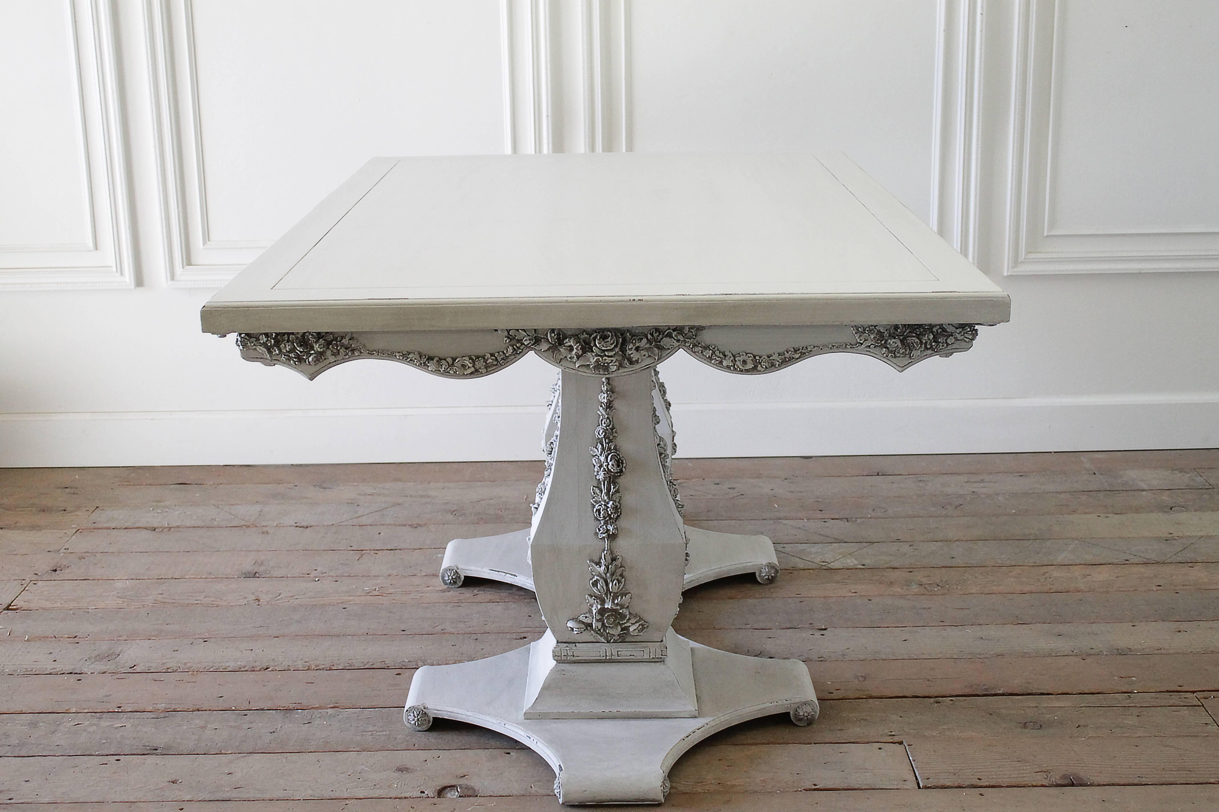 Mid-Century carved dining table with double pedestal base has been painted in our oyster white with distressed and hand glazed finish.
All of the carvings are of large cabbage roses, and are original to this piece.
The table is sturdy, ready for