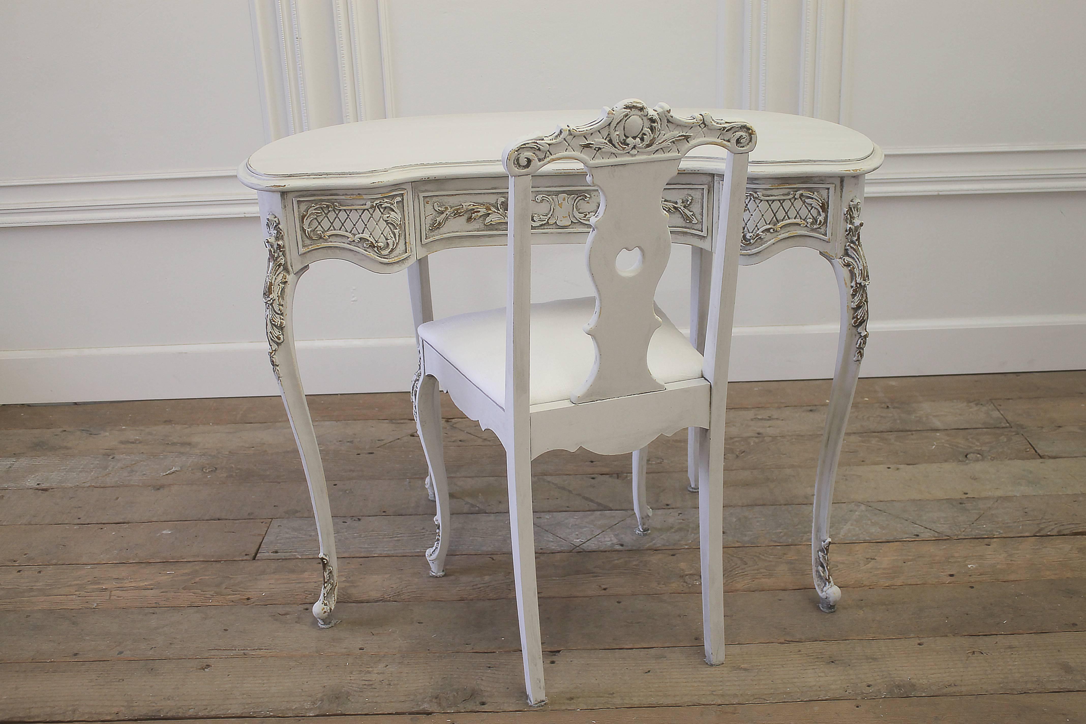 Exquisite French vanity and chair in the Louis XV style. Freshly painted in our signature oyster white paint, and the chair has been reupholstered in a heavy soft white Belgian linen.
The vanity has a single working drawer in the center.