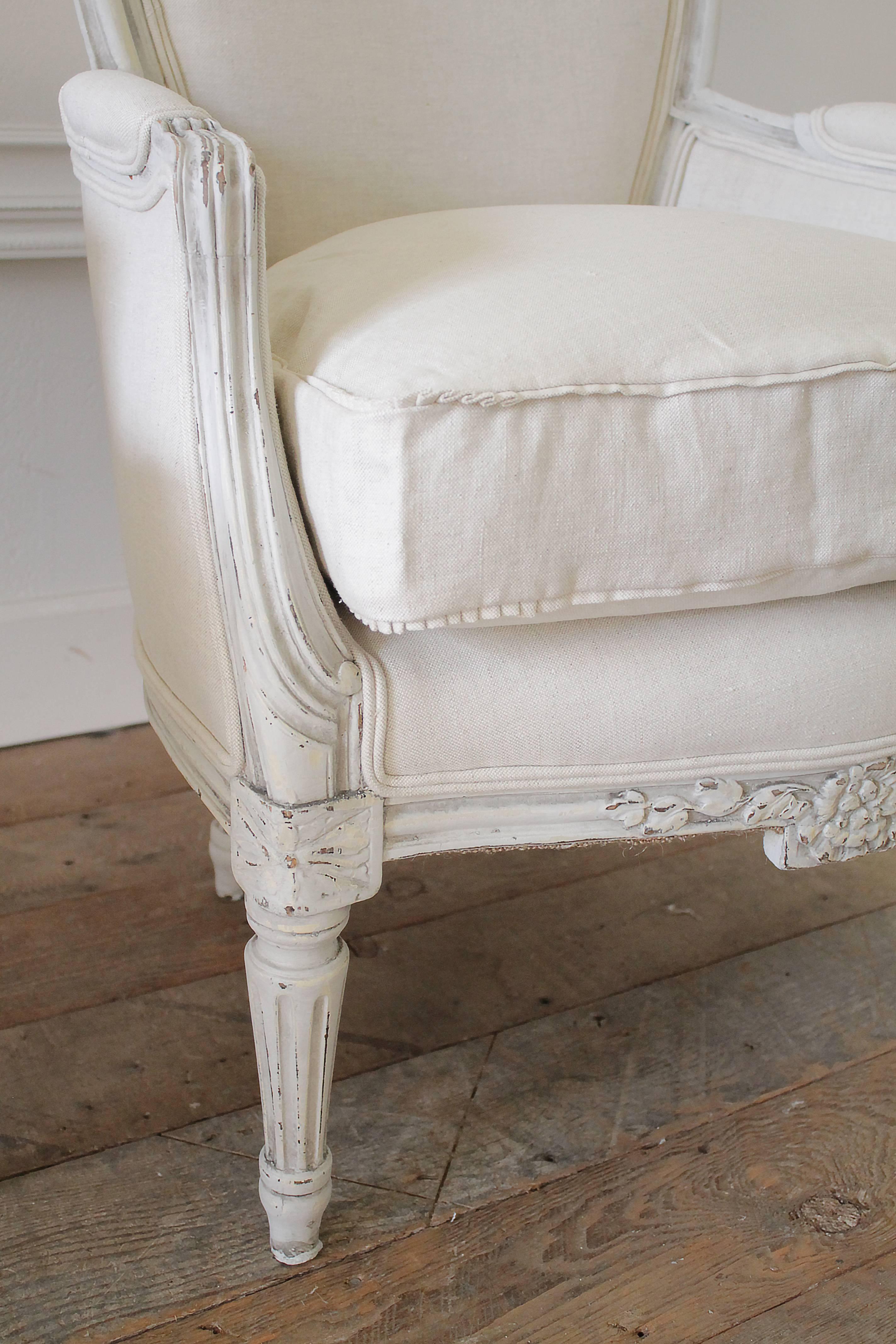 Carved Pair of Painted and Upholstered Belgian Linen Louis XVI Style Bergere Chairs