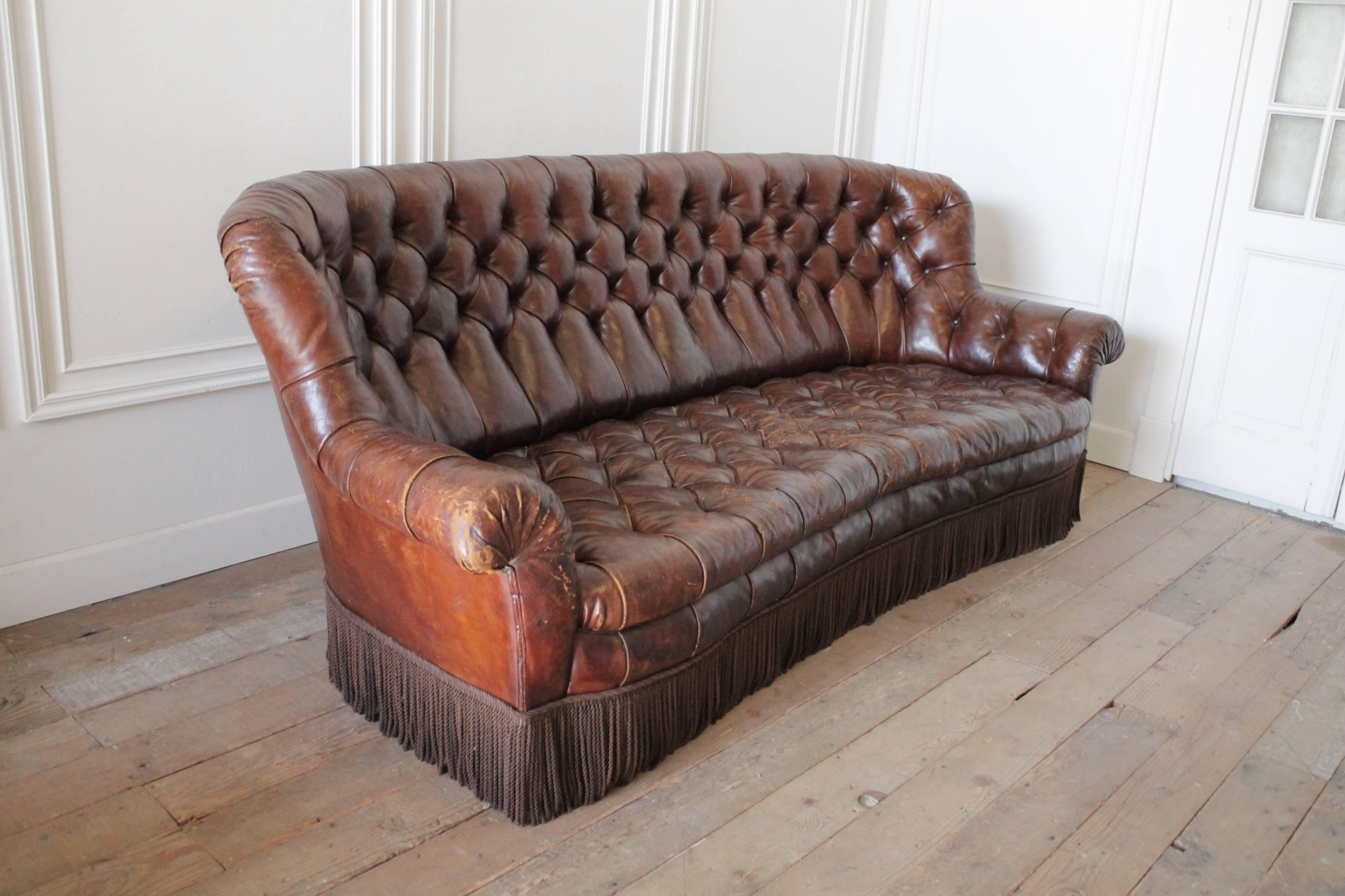 Classic rich brown leather Chesterfield with wonderful patina. This Chesterfield is very unique, the Classic rolled arms, and high back support your back and neck, hugging you, and the deep seat is another great feature making this very comfortable
