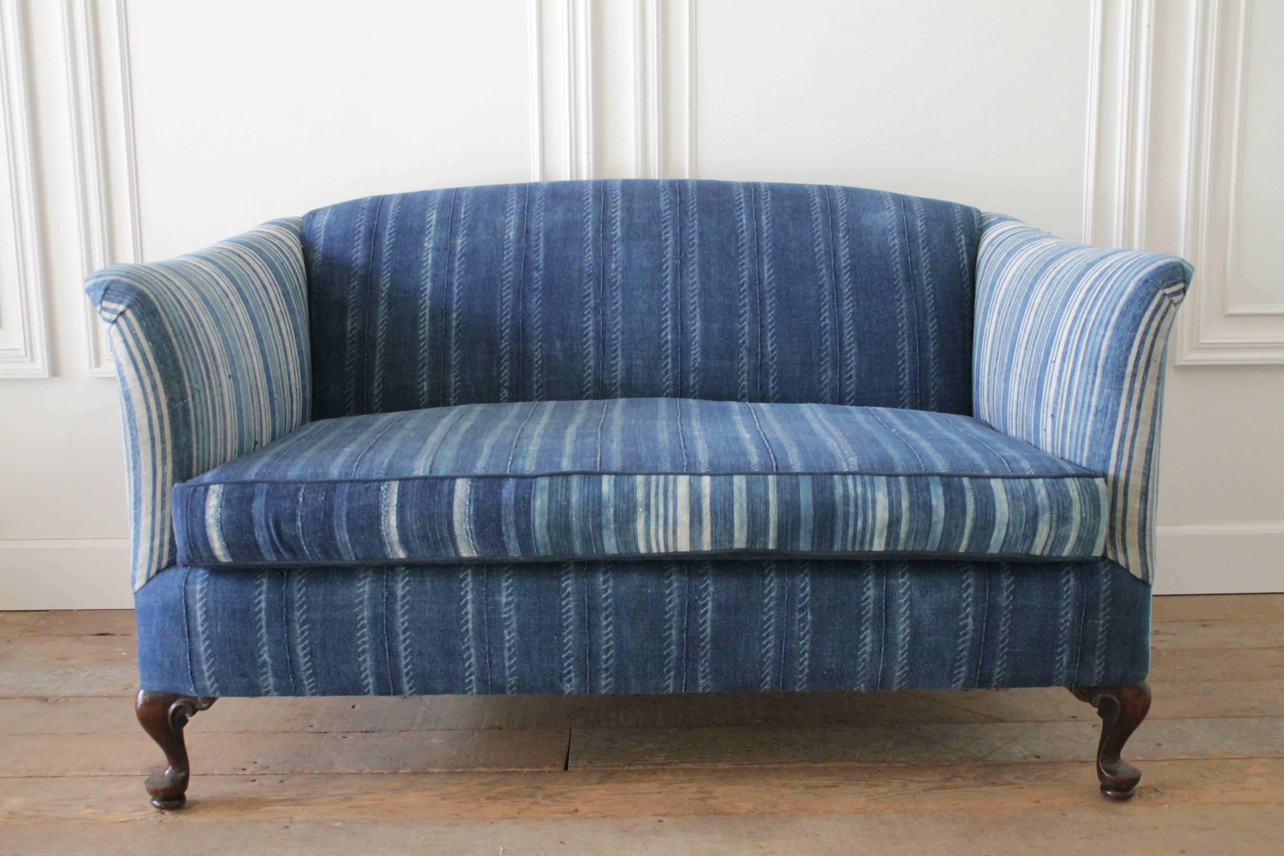 Vintage settee circa 1940 we reupholstered in these beautiful indigo African mud cloths. Thick and heavier weight, with multi tonal stripes and patens.
This settee is very comfortable and ready for everyday use. Perfect for a beach house, play