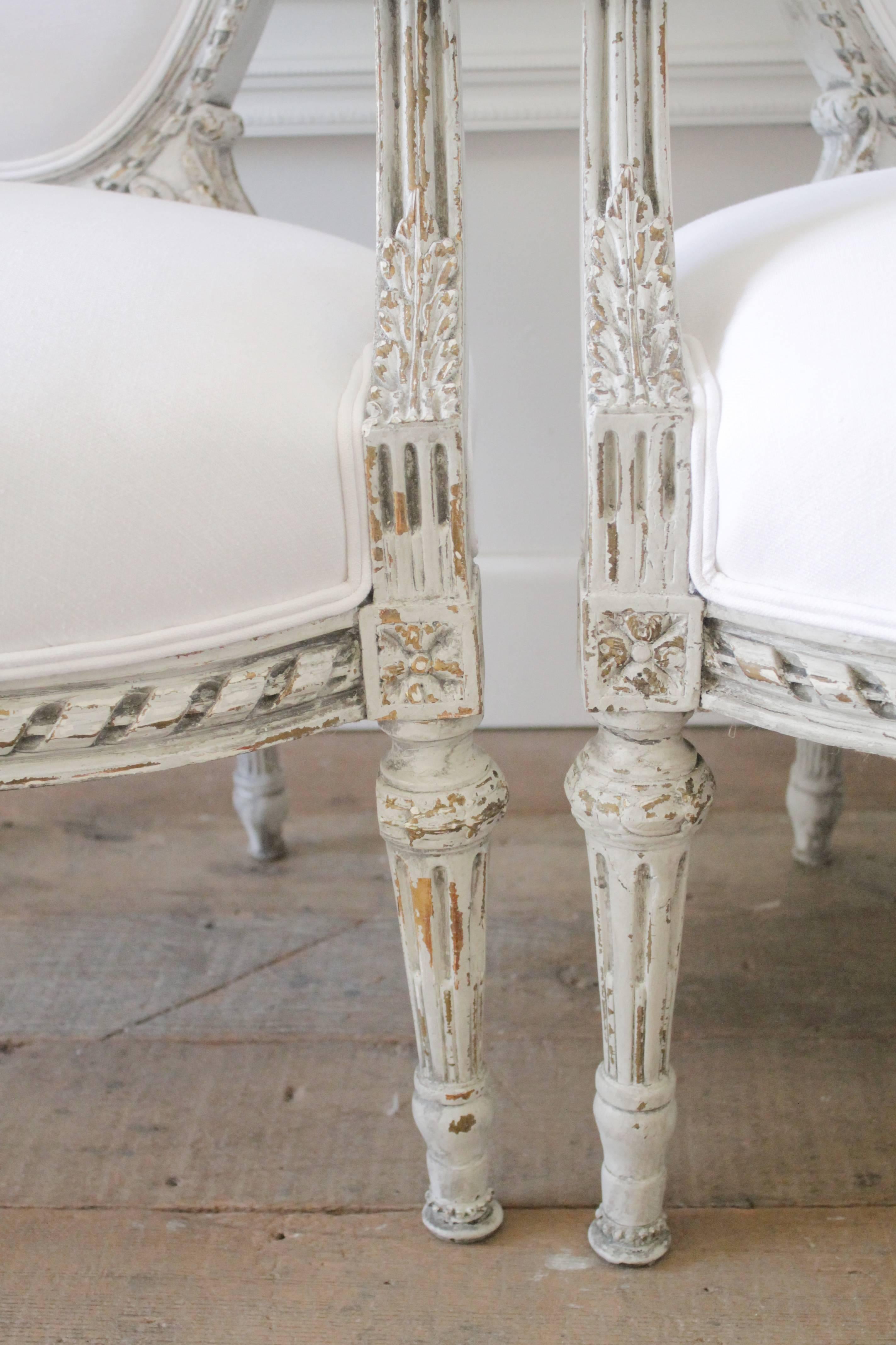 19th Century Four Painted and White Linen Upholstered Louis XVI Ribbon Carved Armchairs