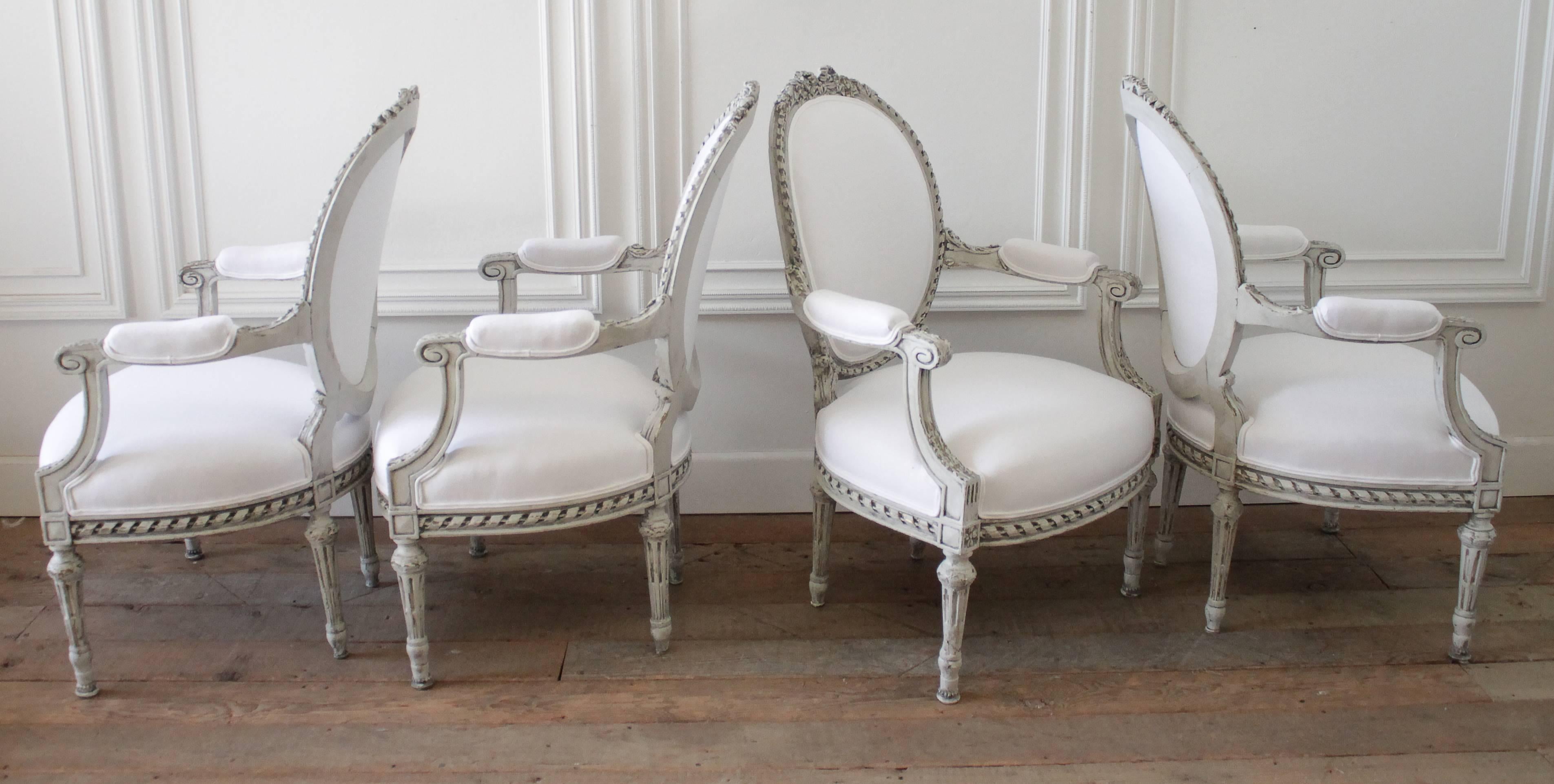 Four Painted and White Linen Upholstered Louis XVI Ribbon Carved Armchairs 2