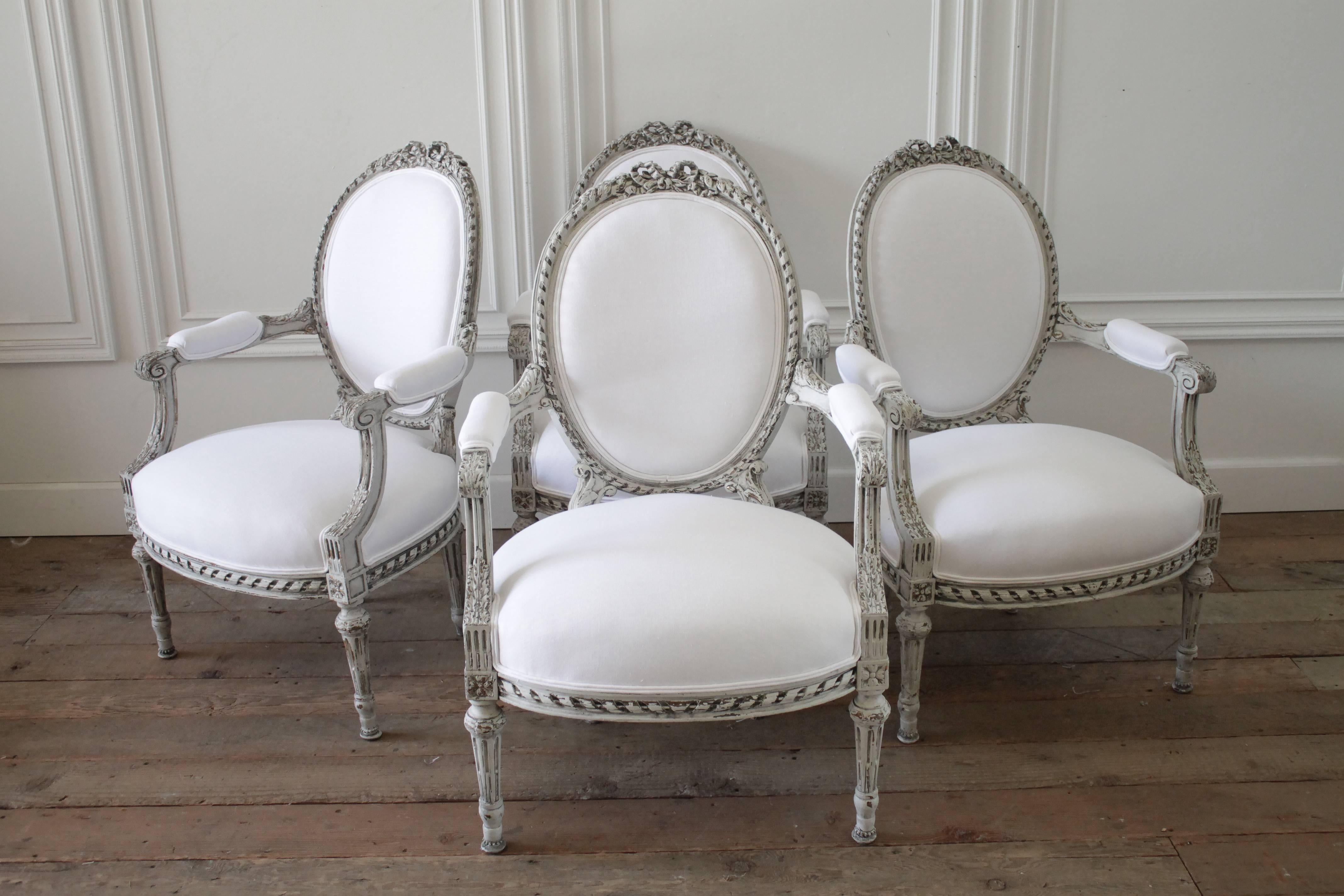 Four Painted and White Linen Upholstered Louis XVI Ribbon Carved Armchairs 4