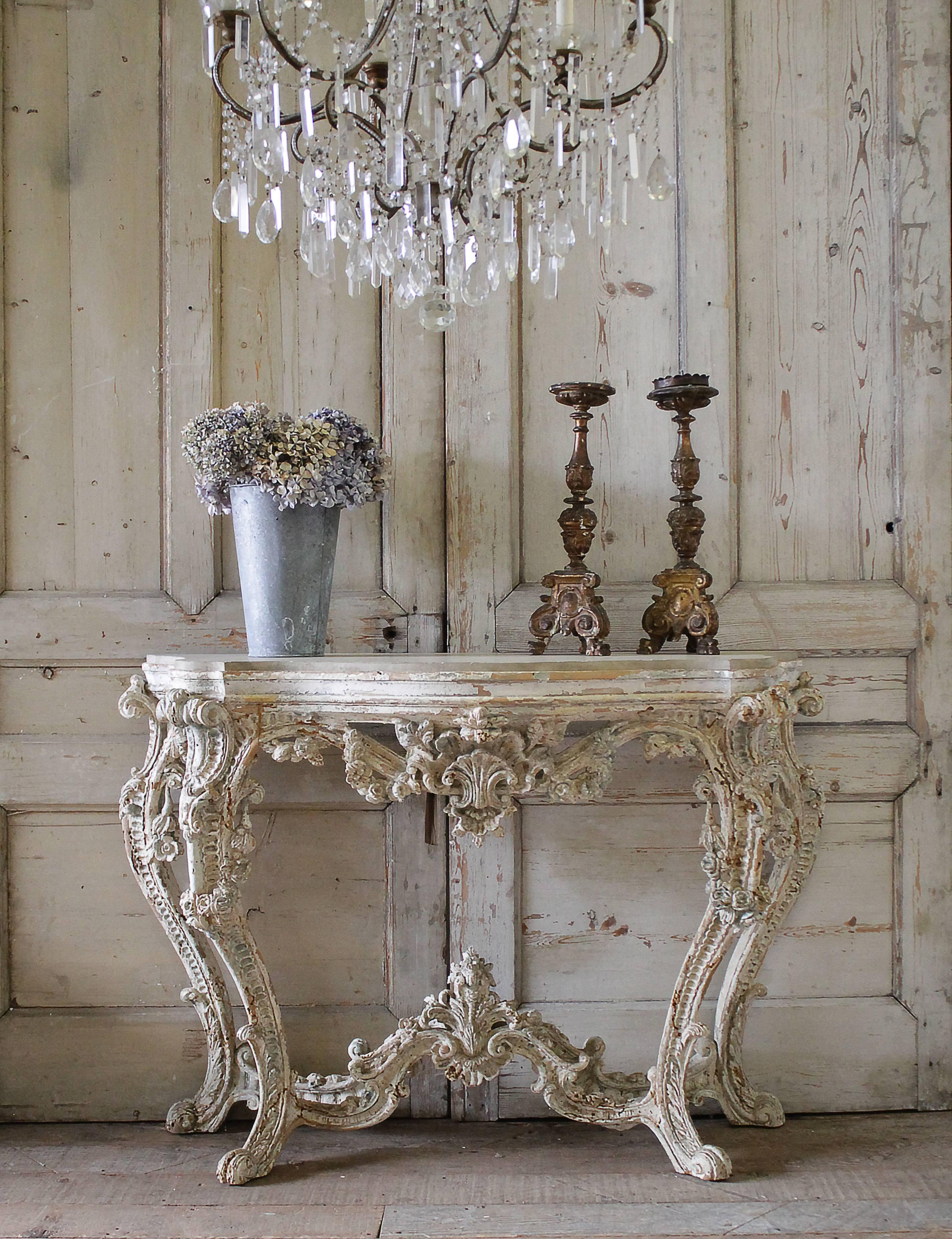 A very elegant French early 19th century Louis XV style patinated freestanding console. The console with exquisite and rich carvings throughout is raised by four carved cabriole feet. Beautiful scrolls and shell carvings with floral swags on the