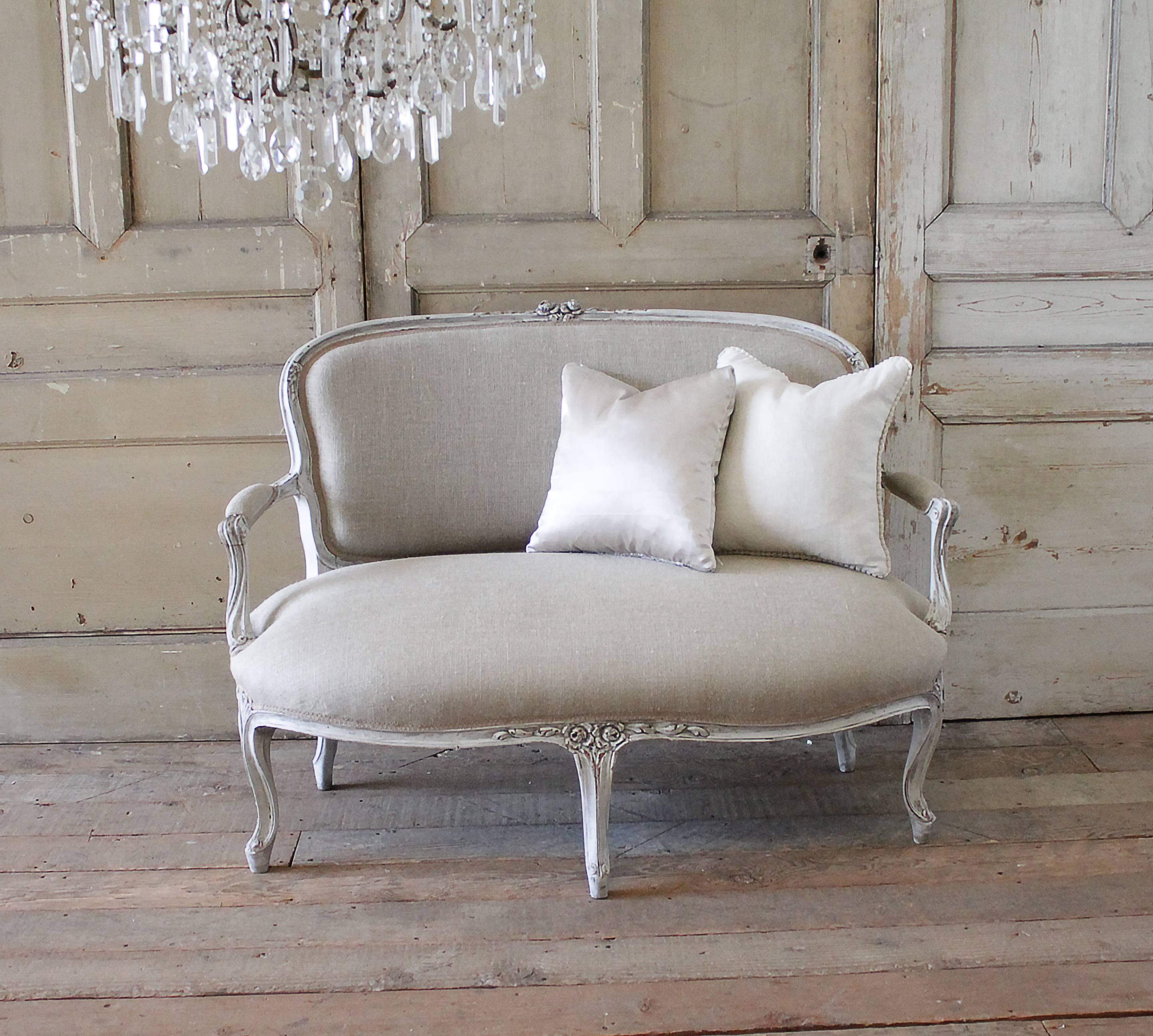 Beautiful settee with large hand-carved roses and floral decorations, we have painted this in our signature oyster white with a soft muted antique glaze, giving the paint a grey tone while enhancing the carvings. Slightly distressed, this settee is