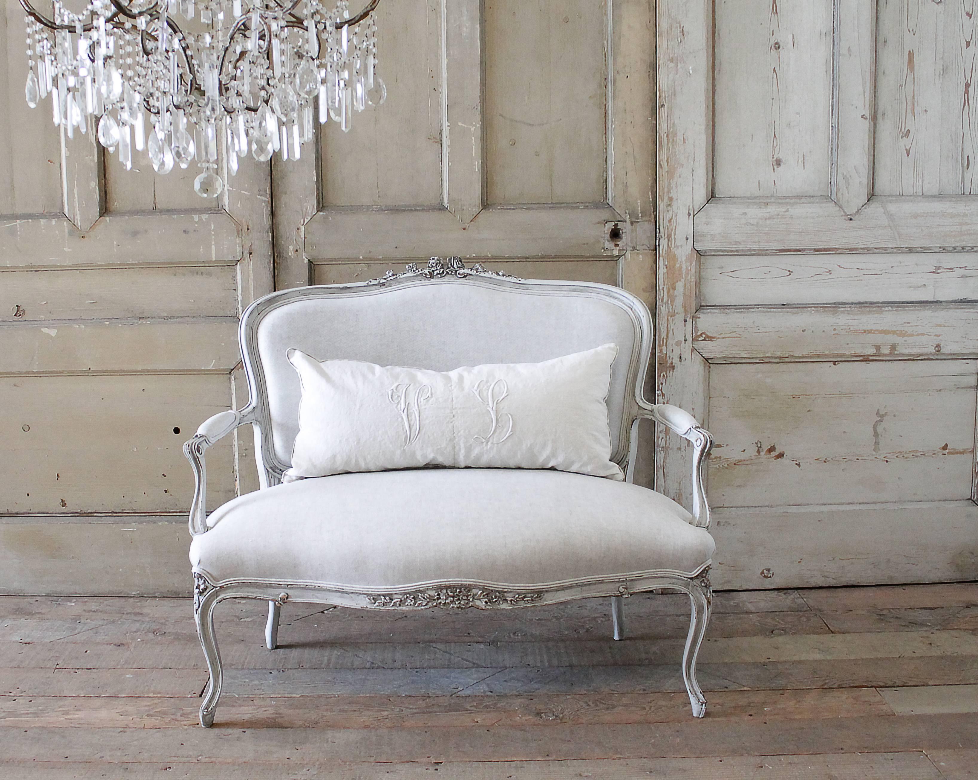 Beautiful settee with large hand-carved roses and floral decorations, we have painted this in our signature oyster white with a soft muted antique glaze, giving the paint a grey tone while enhancing the carvings. Slightly distressed, this settee is