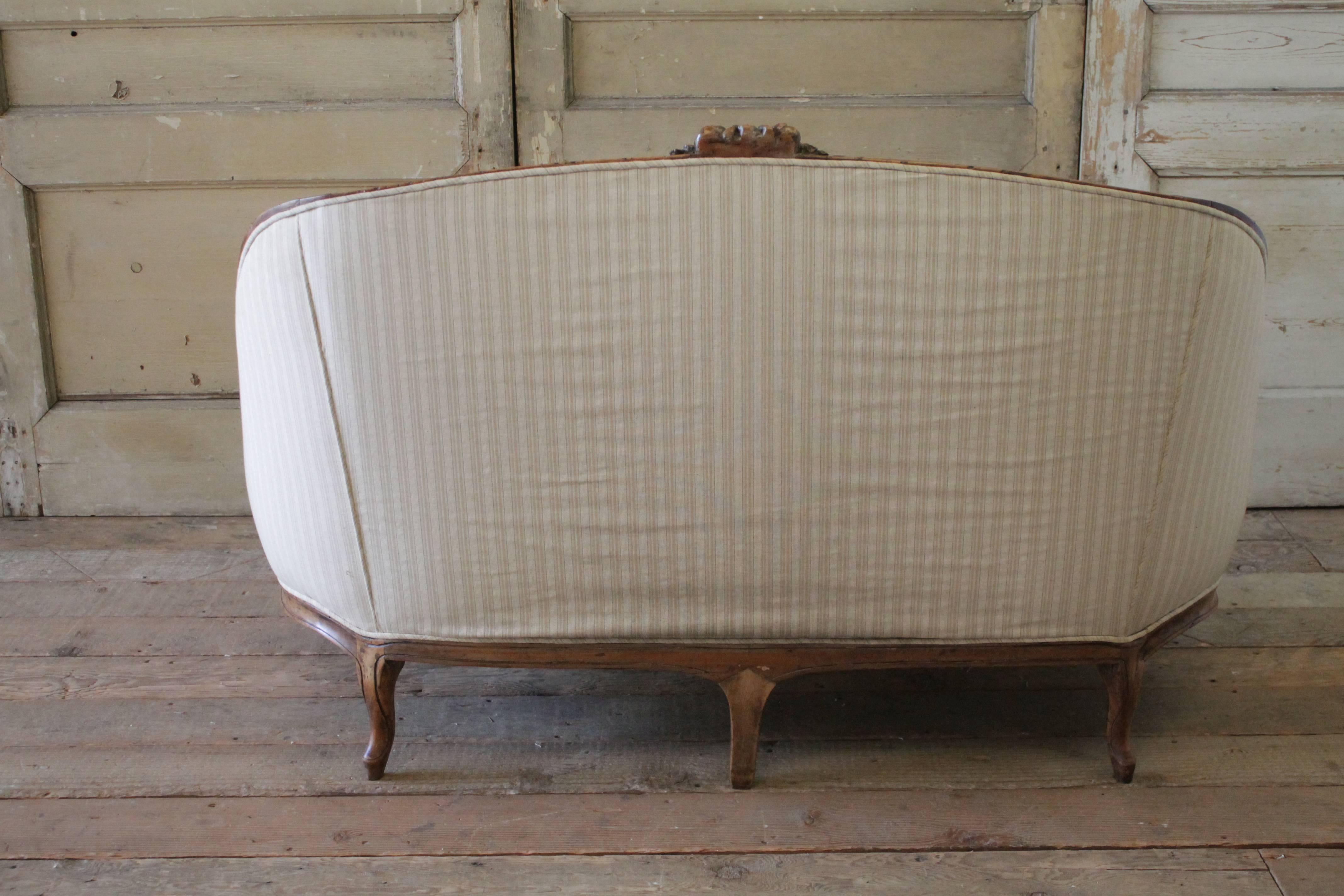 French 19th Century Walnut Rose Carved Settee Upholstered in Stripe Linen