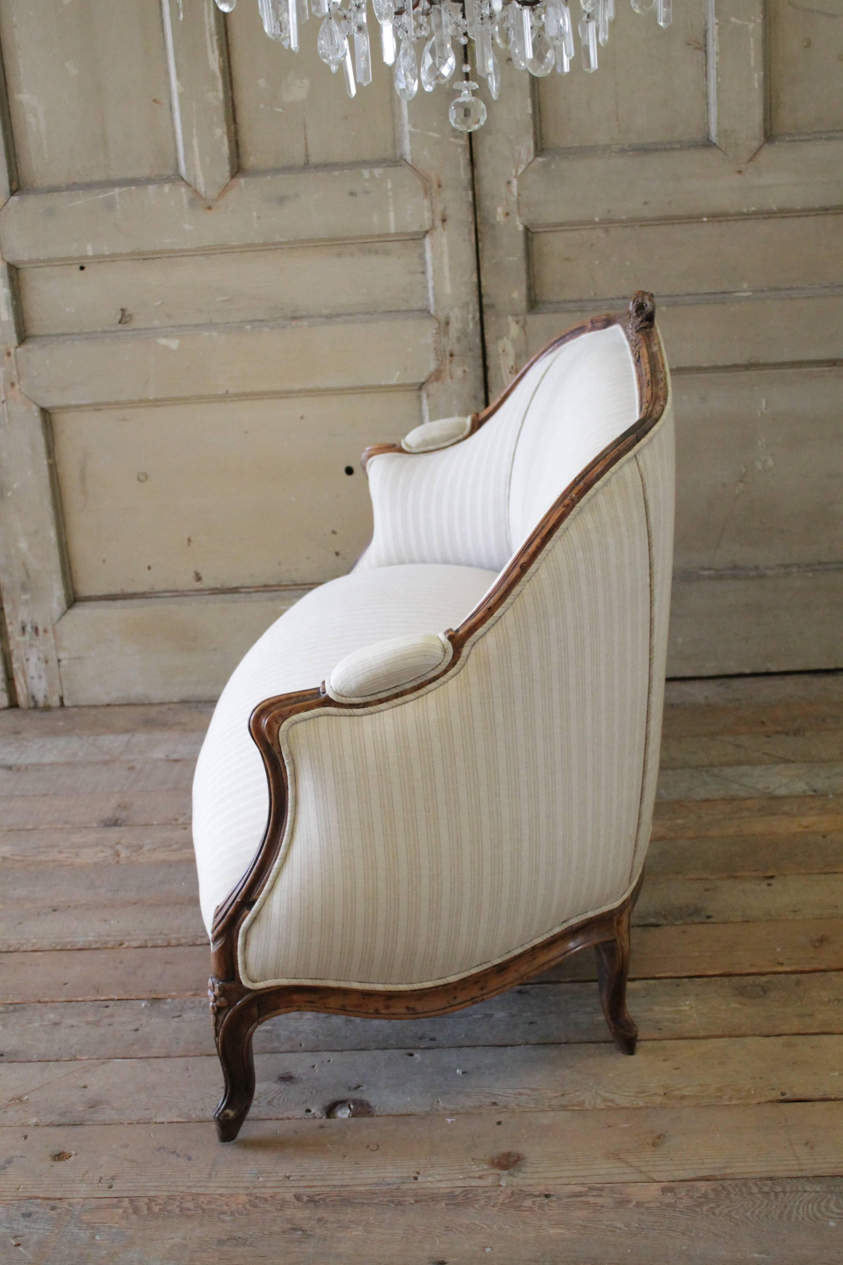 Hand-Carved 19th Century Walnut Rose Carved Settee Upholstered in Stripe Linen