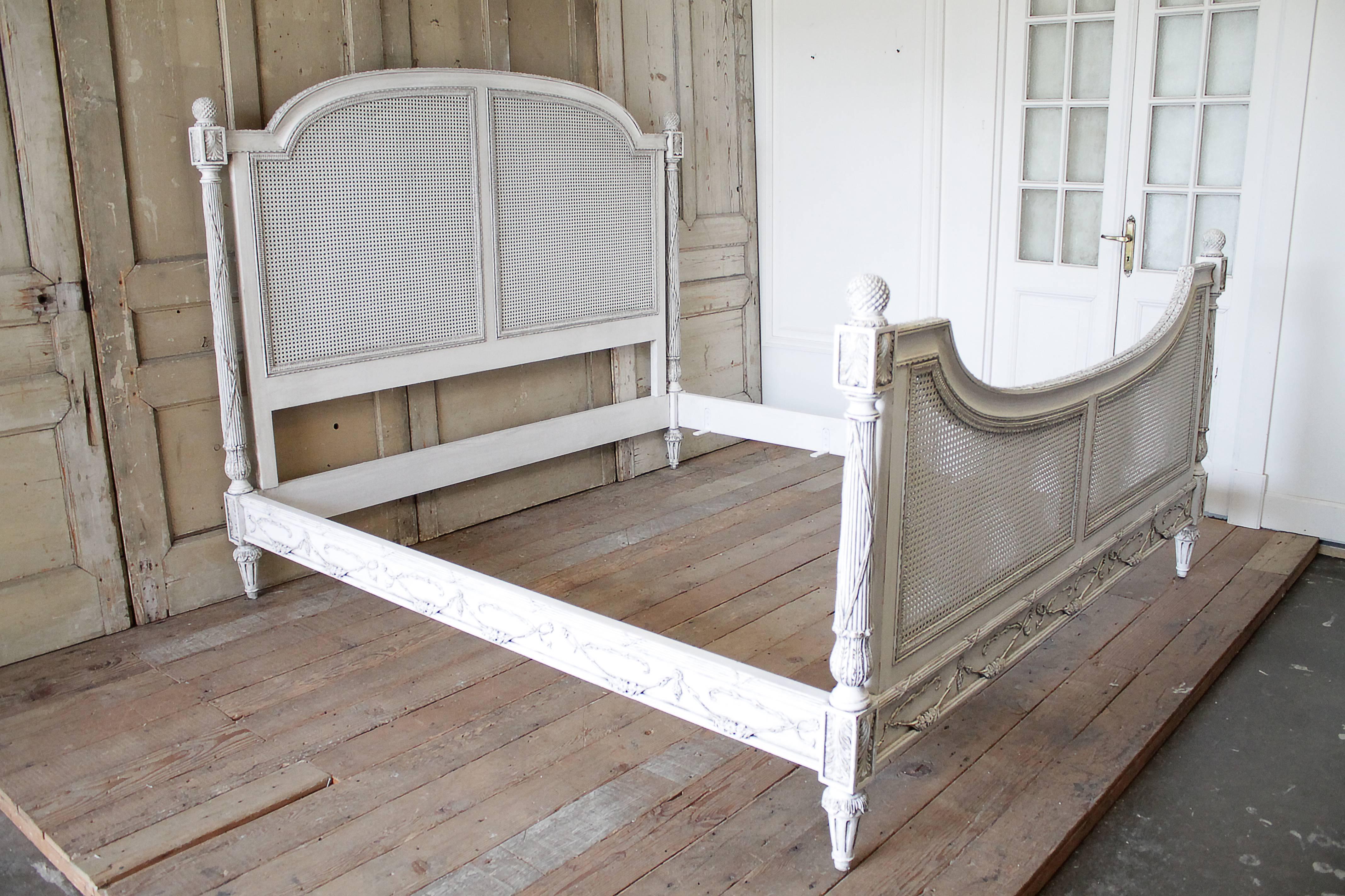 Beautiful vintage king-size bed has been painted in our oyster white finish. Double cane is in flawless condition, no holes for breakage. Fluted post with floral swags decorate the rails and foot of the bed. Extremely sturdy when assembled, includes