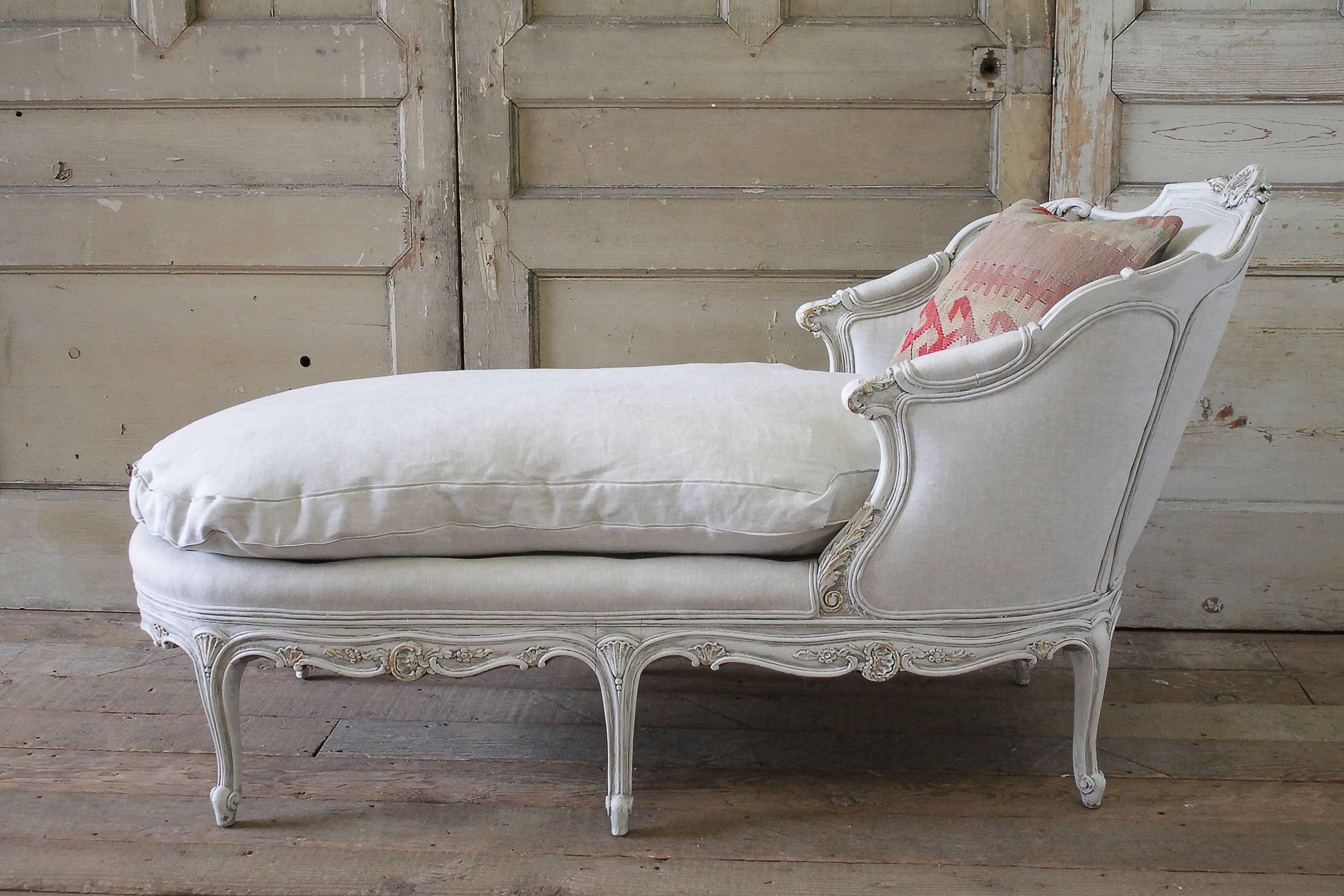 Lovely antique chaise longue in the Louis XV style, we have repainted the frame in our oyster white, originally this was a dark creamy yellow color with gilded carvings. Our oyster white is off-white, with subtle tones of grey. Reupholstered in our