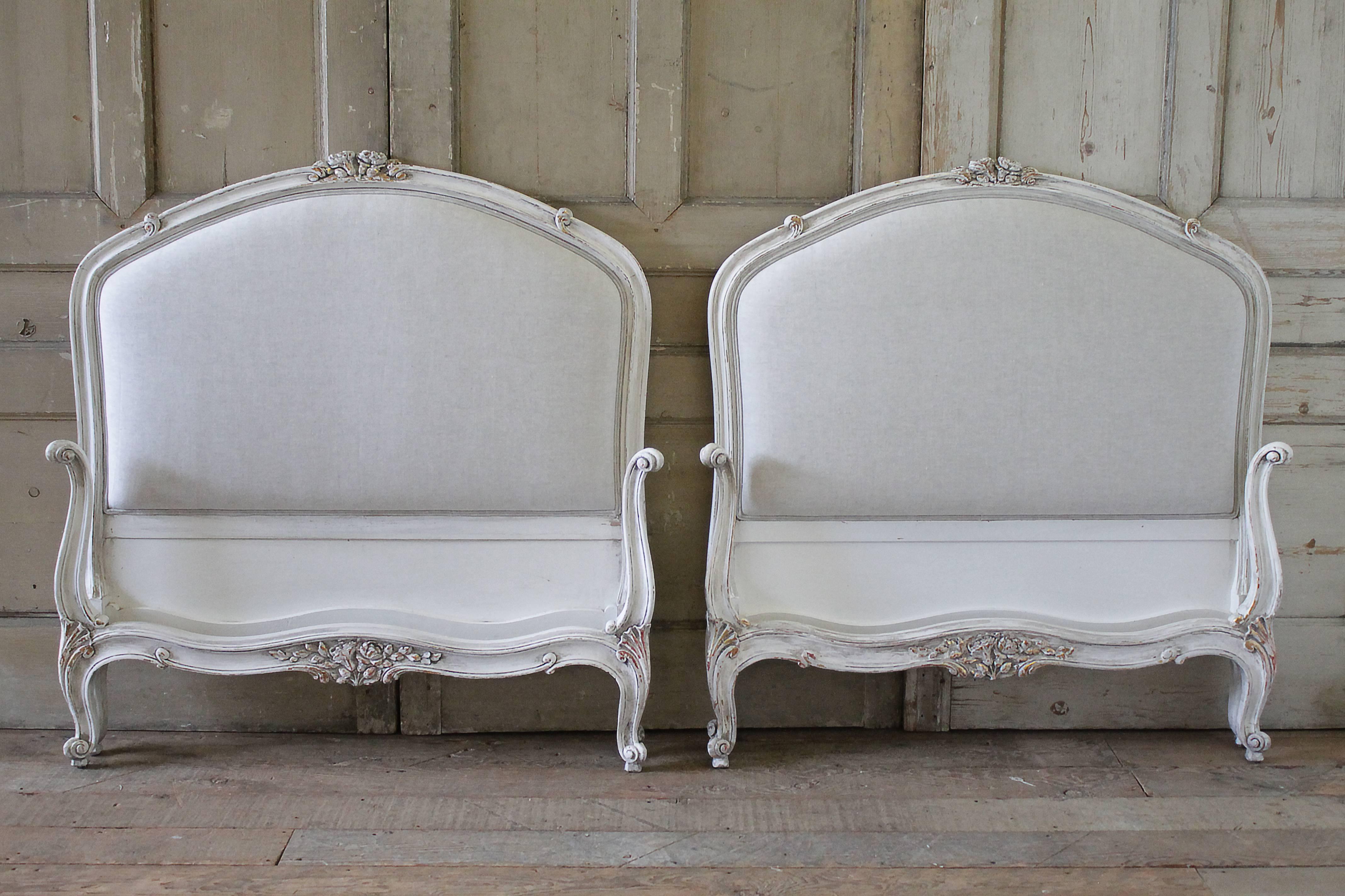 Lovely pair of painted and upholstered Twin size French beds.
These can be used with a standard US Twin mattress.
We have painted these in our antique oyster white finish, it is a soft white with subtle grey tones. Original gilt highlights are