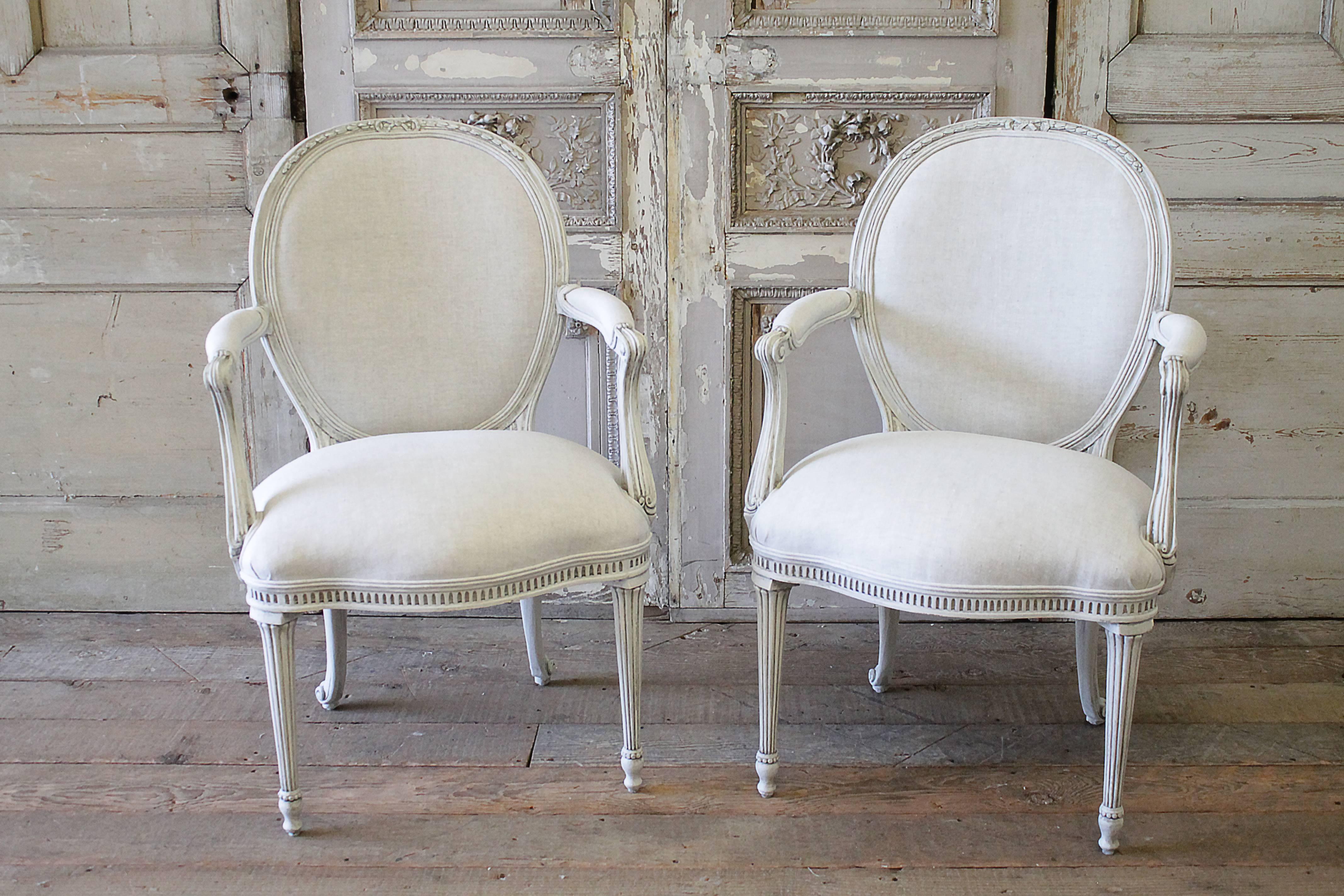 Custom-made dining chairs by EJ Victor painted in our soft oyster finish. A soft pale grey with hand rubbed antique patina. Pale blue grey painted finished peeking through the top ribbon carvings. We have reupholstered these in a greige natural