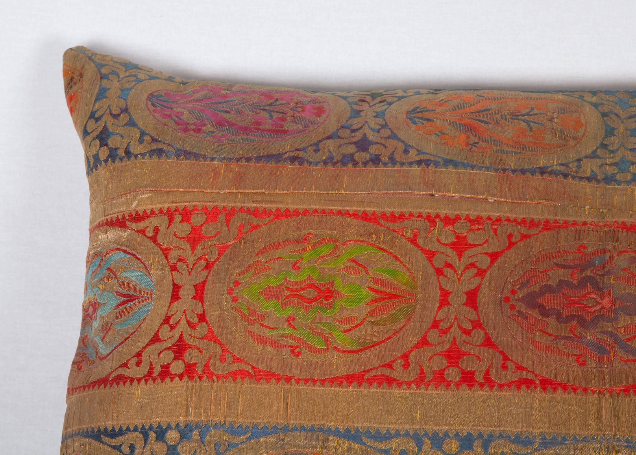 The pillow is made out of an early 20th century, brocaded textile from Central Asia, probably Uzbekistan.
It does not come with an insert but it comes with a bag made to the size and out of cotton to accommodate the filling.
The backing is made of
