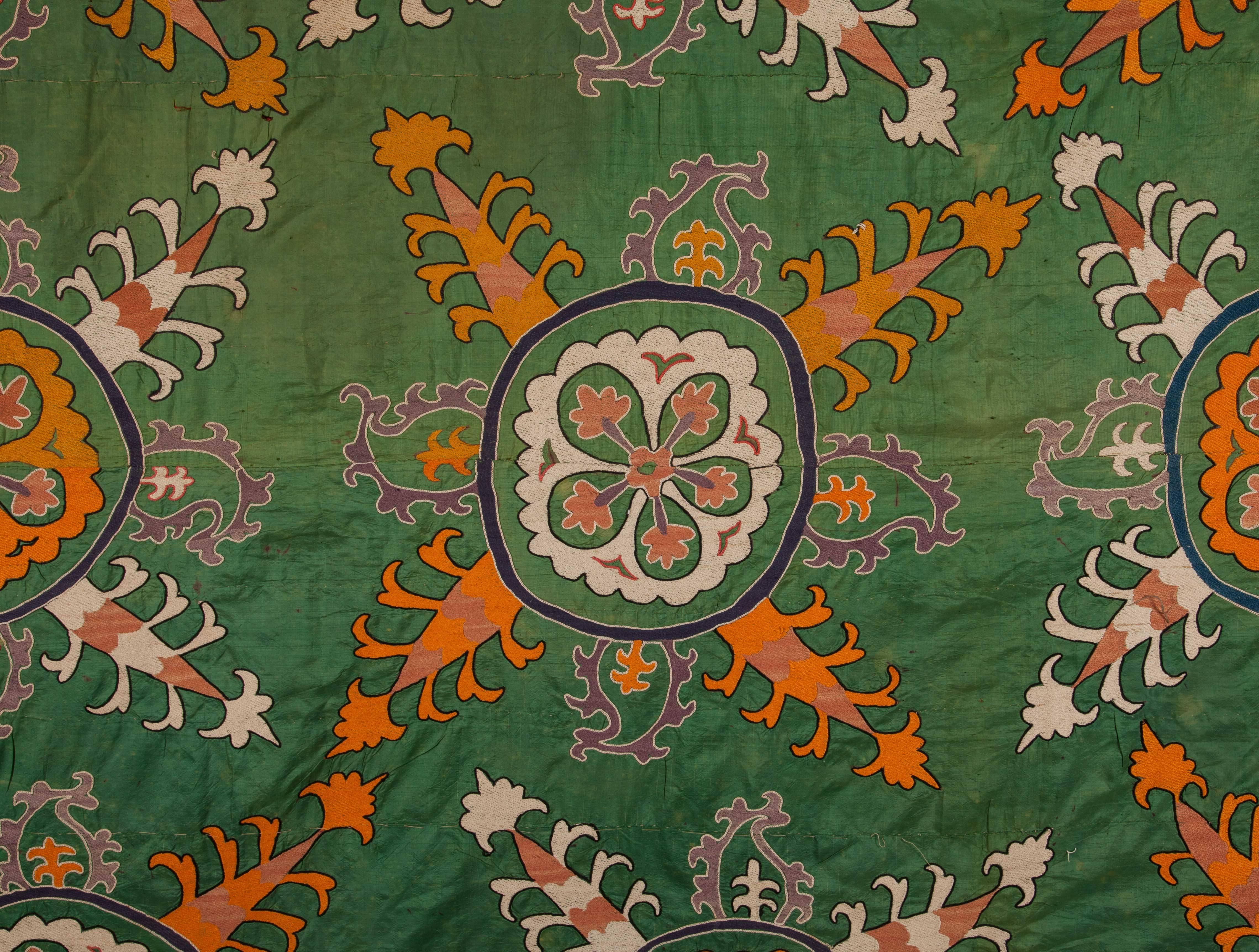 A rare example to Suzanis from Ferghana Valley, Uzbekistan with a very unusual Russian cotton roller print textile. The embroidery is done on a very fine green silk in very fine stitches in silk.
 