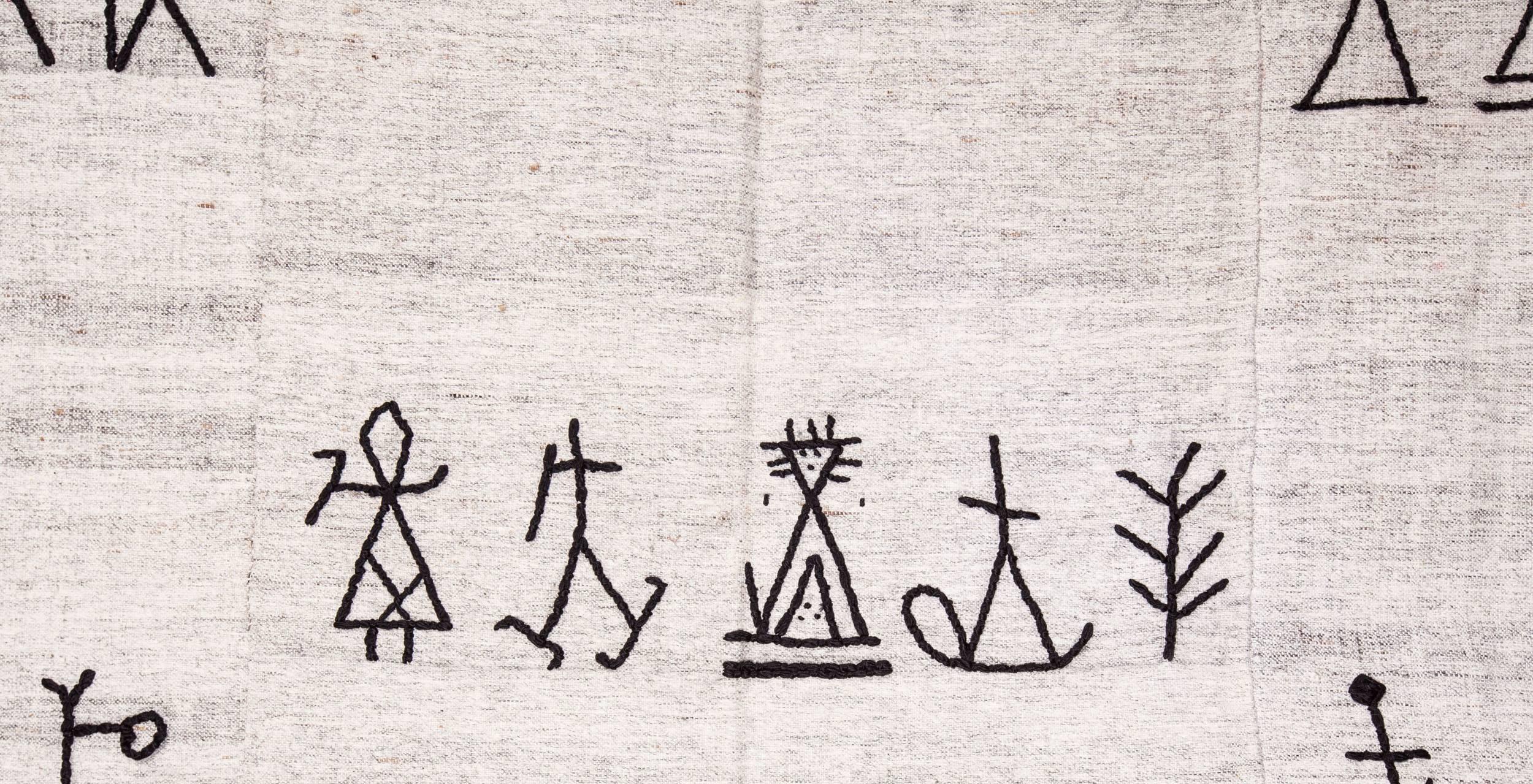 I have always been fascinated by petroglyphs and shaman imagery and I have collected design elements from Shaman drums and rock carvings. I got a group of embroiderers and gave the design pool and got them embroidered in black silk onto Vintage