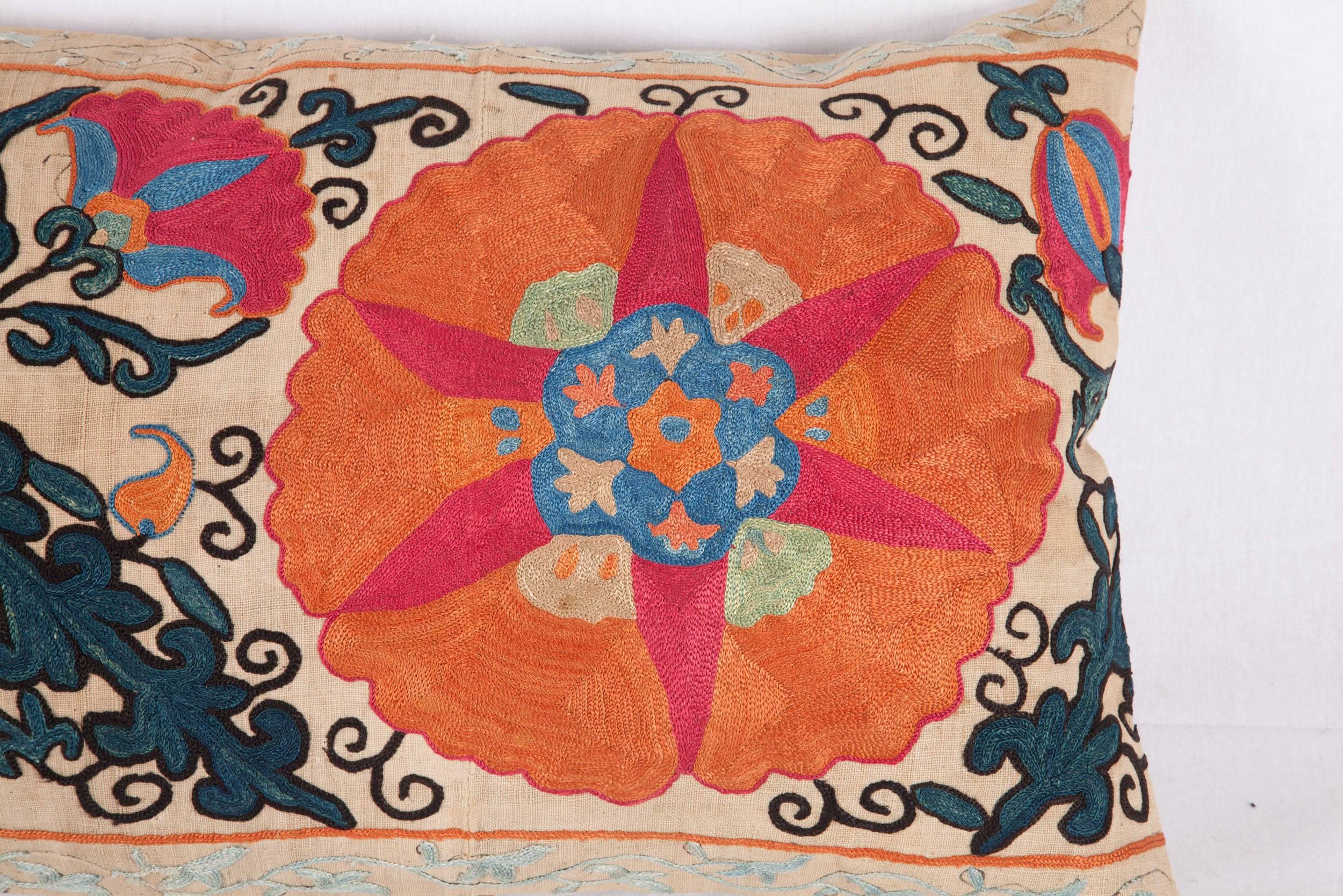 The pillow is made out of mid-19th century Uzbek Suzani fragment.
It does not come with an insert but it comes with a bag made to the size and out of cotton to accommodate the filling. 
The backing is made of linen. 
 Please note filling is not