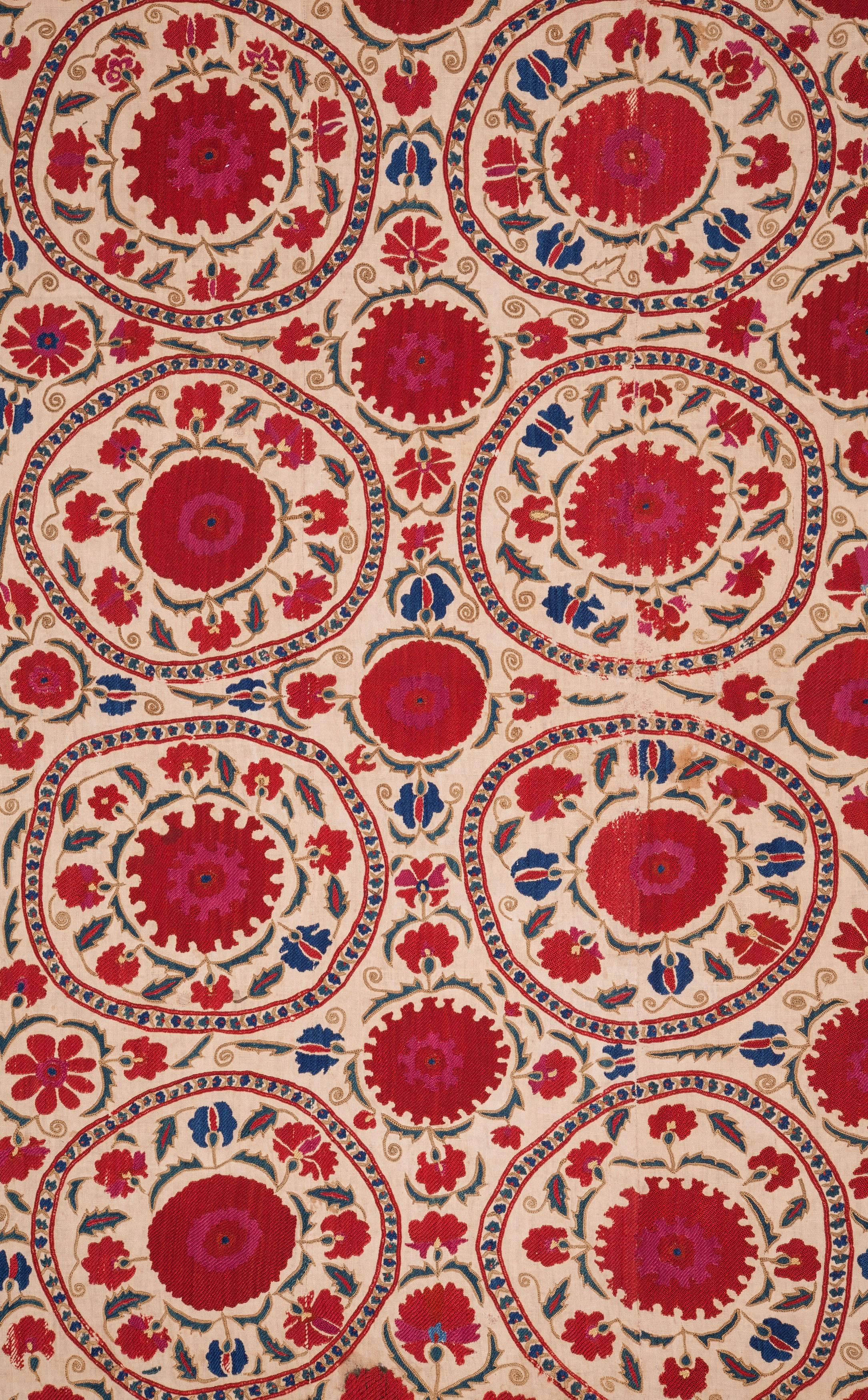 A great Suzani probably dating back to 1850s or 1860s. Fine silk stitches on a cotton background. The piece had no lining so I got a linen lining put on it. Measures: 5'8''x 8'1''.
     