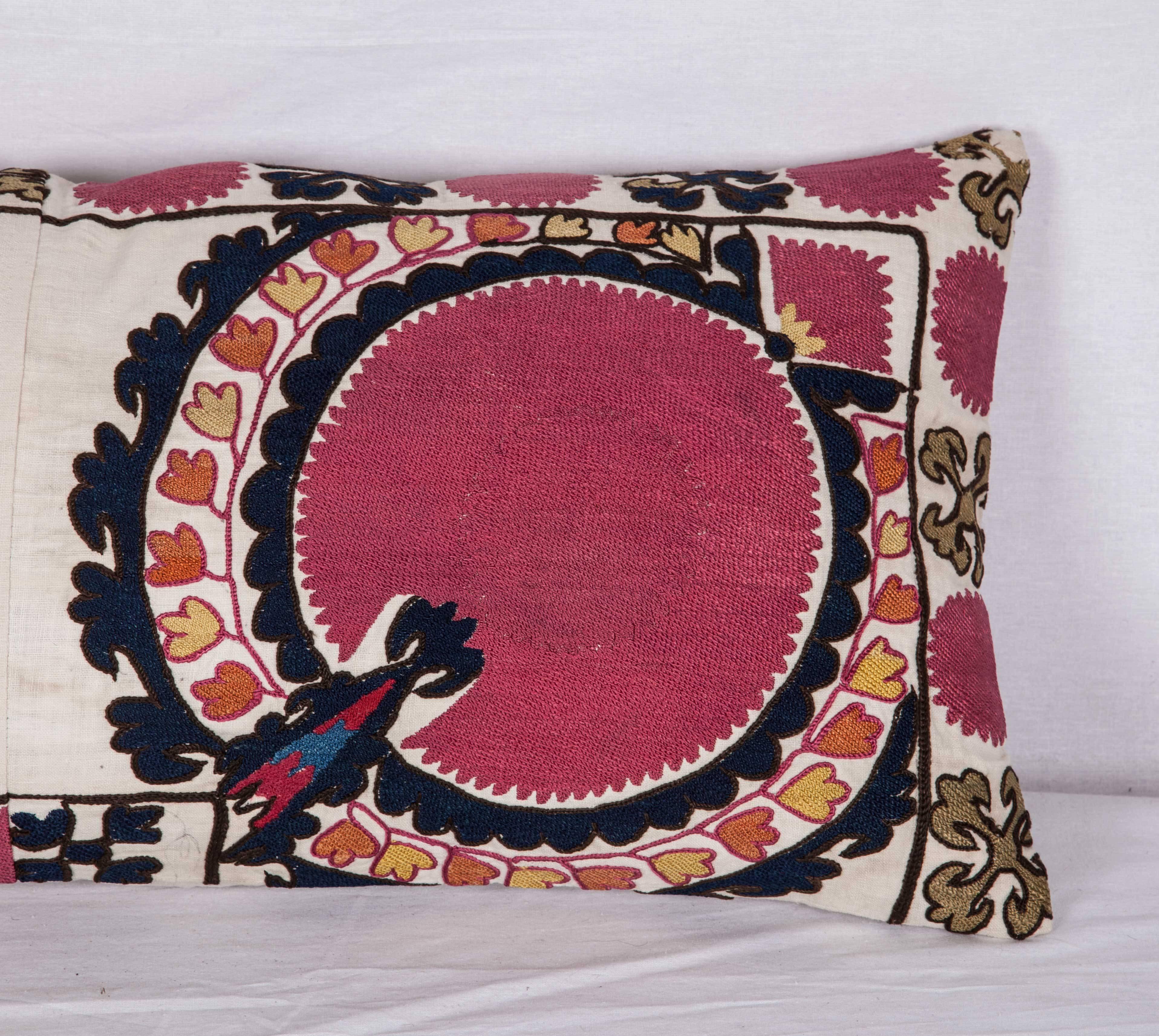The pillow is made out of a 19th century, Uzbek silk Suzani fragment.
 It does not come with an insert but it comes with a bag made to the size and out of cotton to accommodate the filling. 
The backing is made of linen. 
Please note filling is